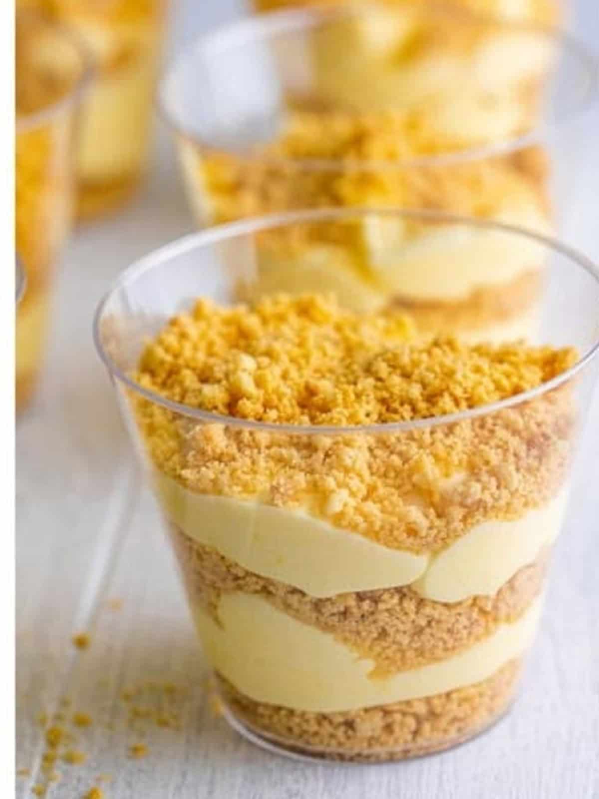 Sand pudding cups topped with golden cookie crumbs.
