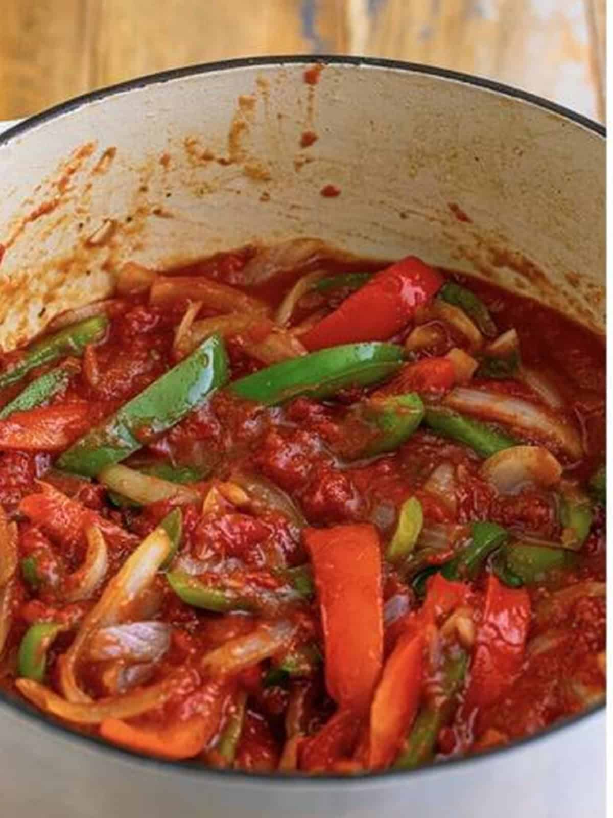 Tomato sauce stirred together with the sauteed peppers and onions until combined.