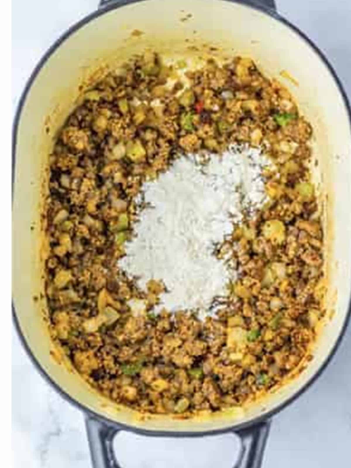 Flour stirred into the sausage and vegetables to thicken the soup.