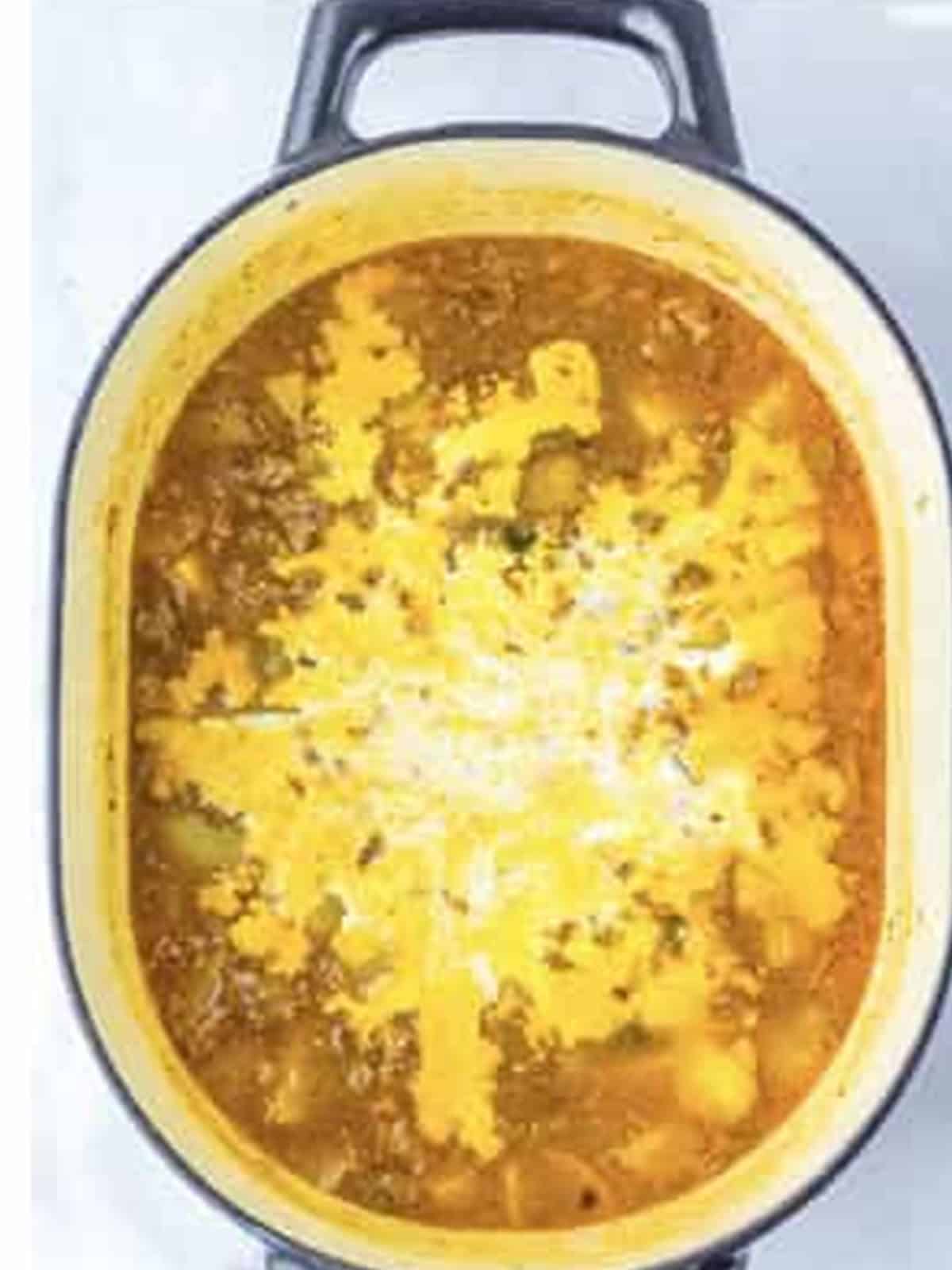 Heavy cream stirred into the simmering creamy potato sausage soup.
