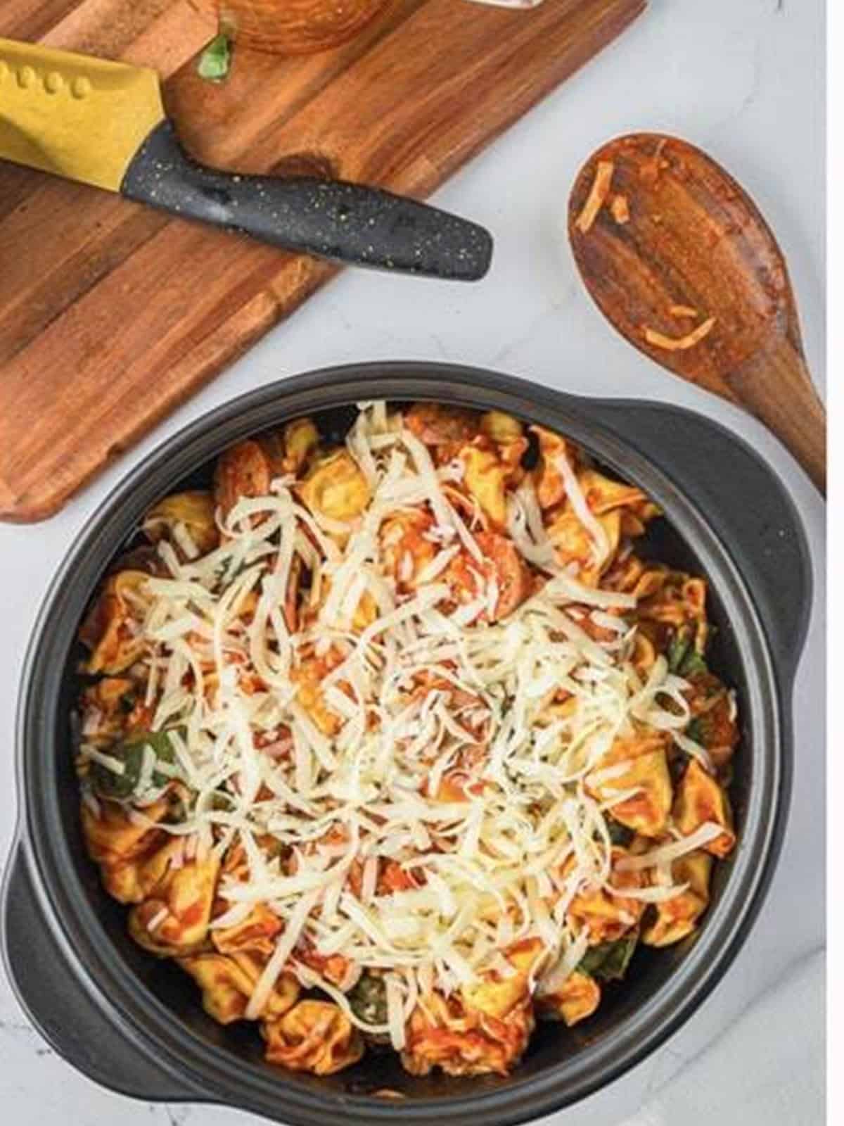 Shredded mozzarella sprinkled over the baked tortellini and sausage.