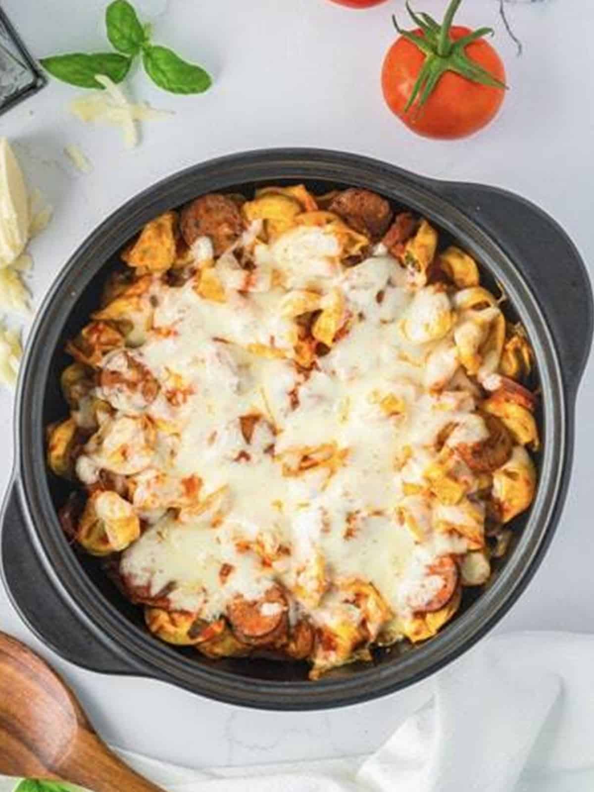Finished sausage tortellini bake with melted golden mozzarella on top.