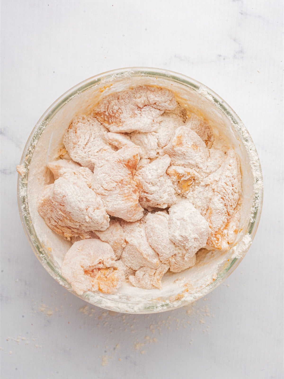 Bite-sized chicken breast pieces tossed in the seasoned cornstarch coating.