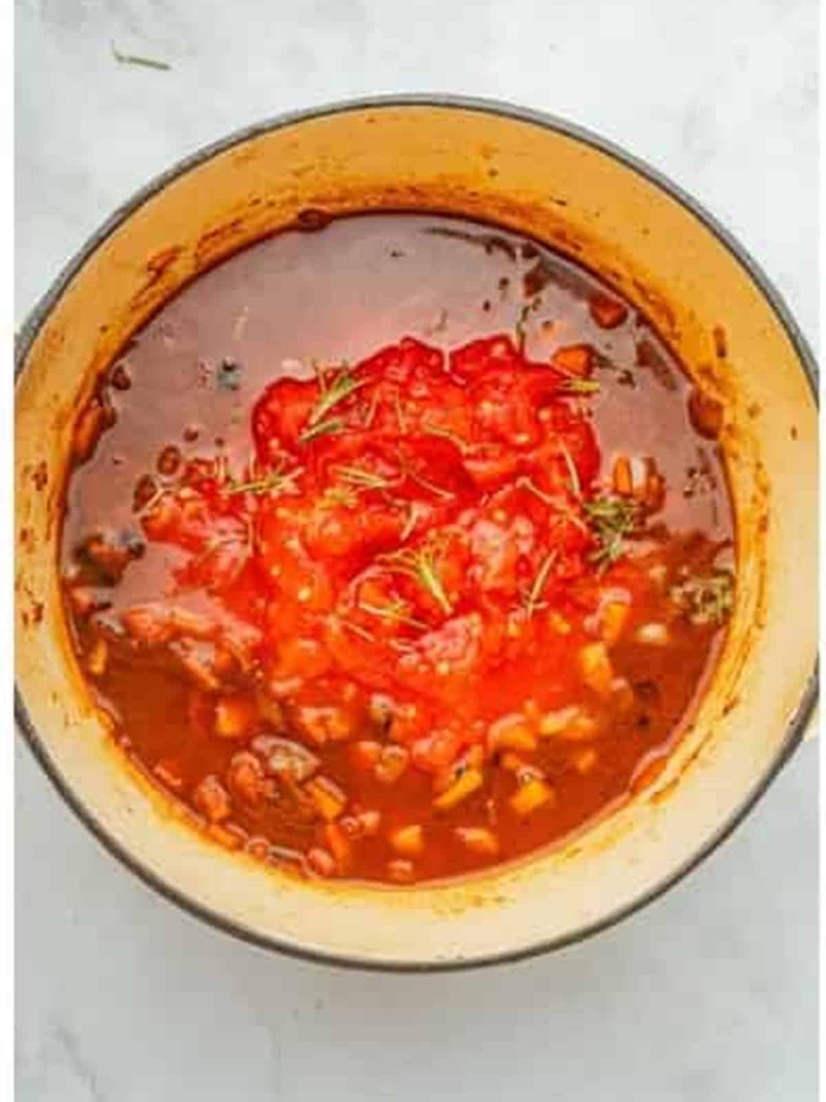 Crushed tomatoes added to the pot after deglazing with red wine for short rib ragu.