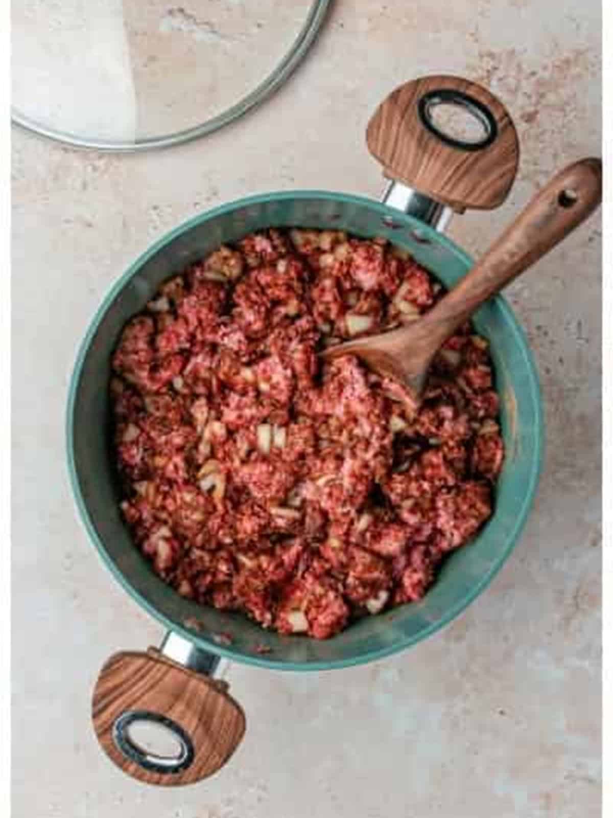 Mixing the beef and spices together for Skyline chili recipe.