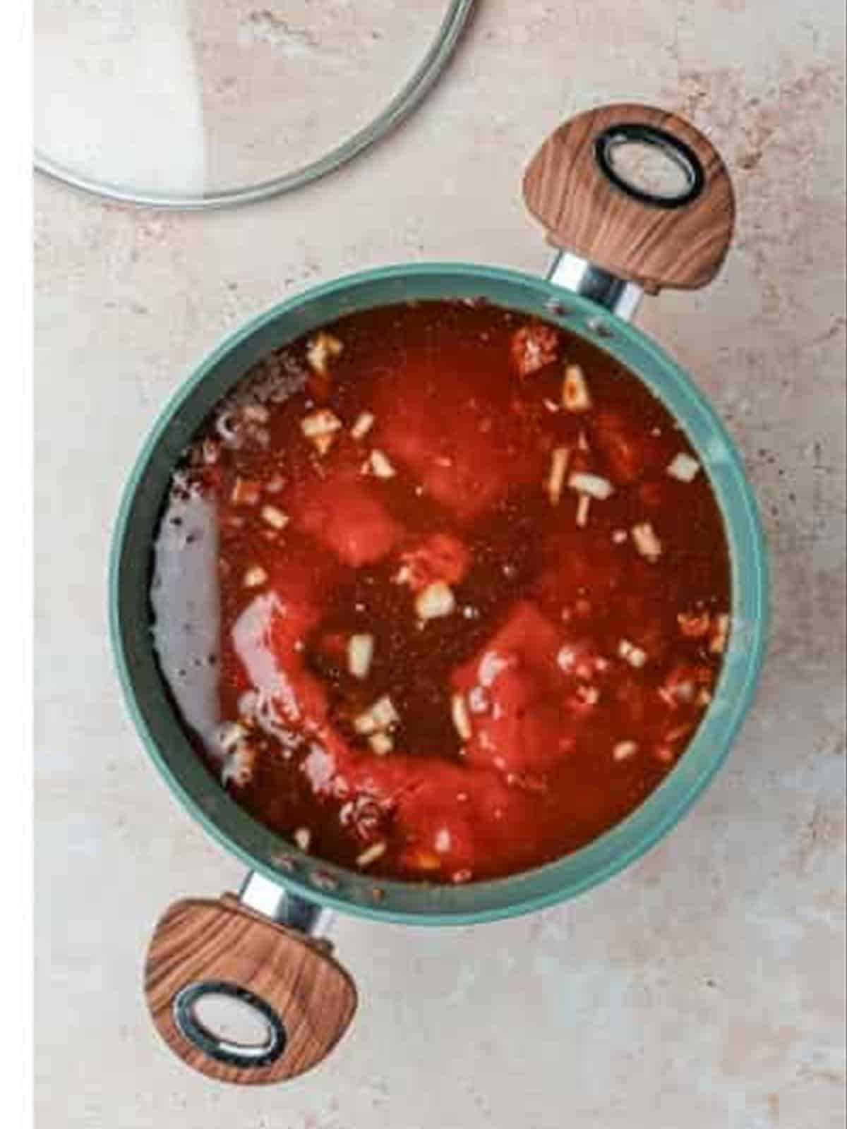 Adding tomato sauce and beef broth to the Skyline chili recipe.