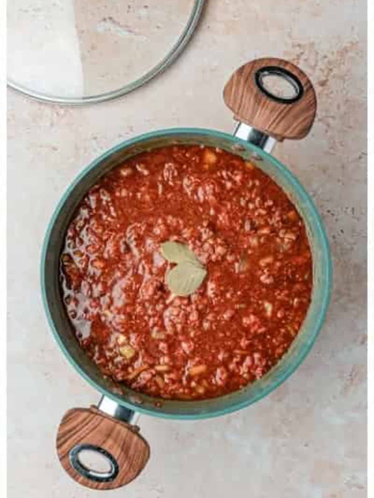 Simmering Skyline chili recipe with a bay leaf.