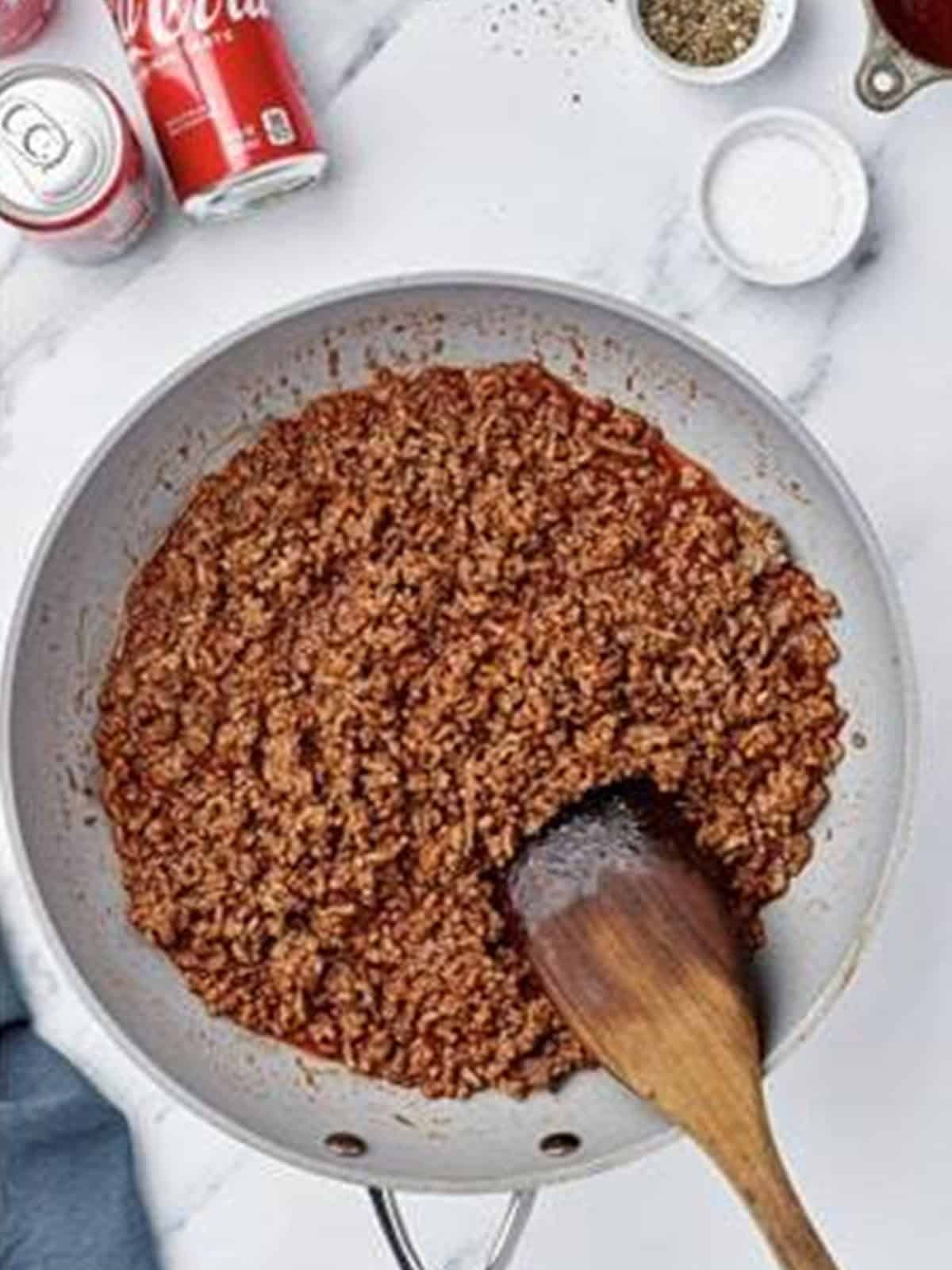 Browned ground beef sloppy joe filling in a skillet.