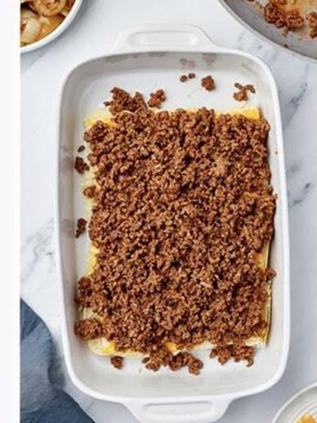 Sloppy joe meat mixture spread over cheese and Hawaiian roll bottoms.