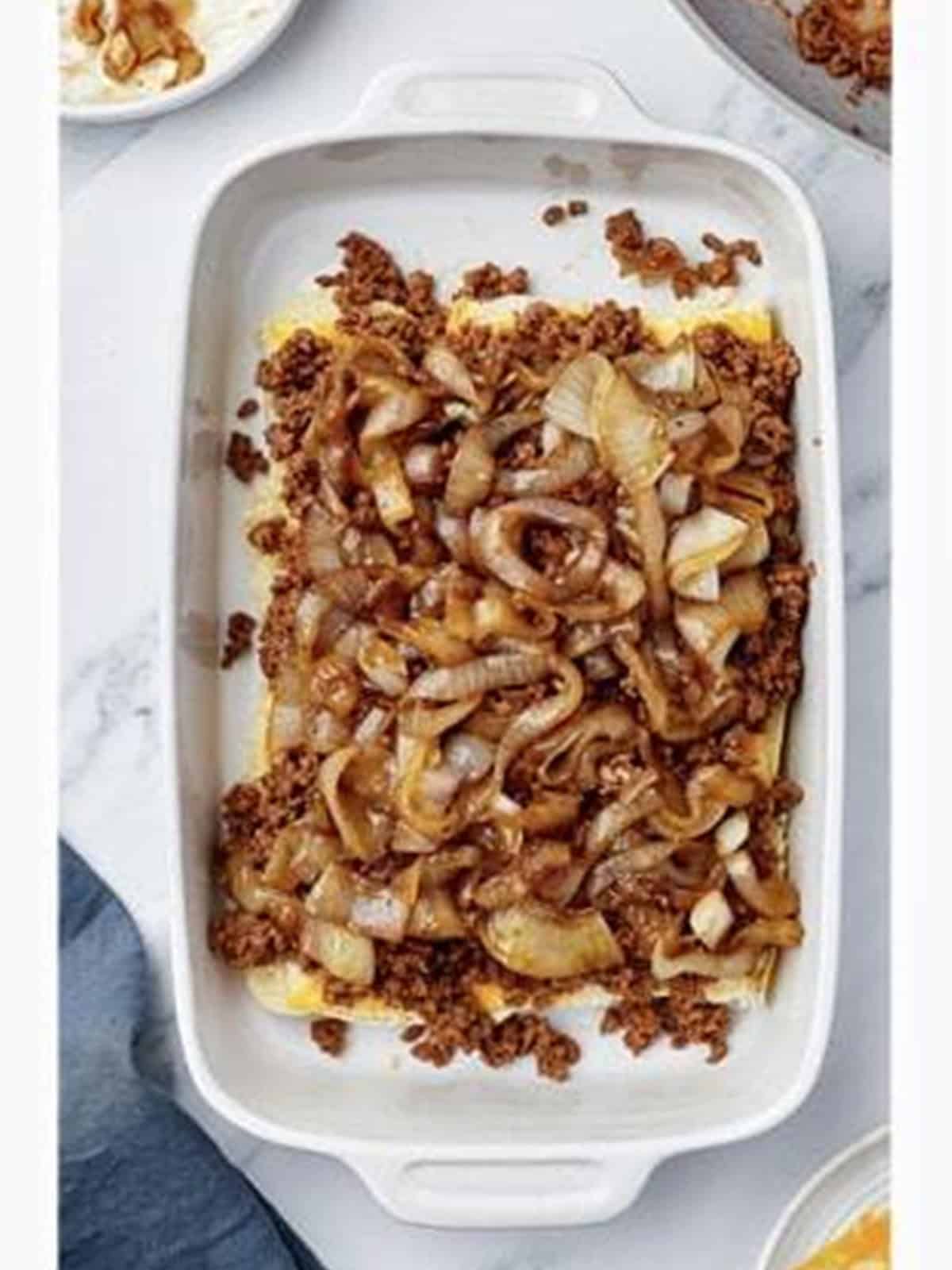 Caramelized onions spread over the sloppy joe meat on the sliders.