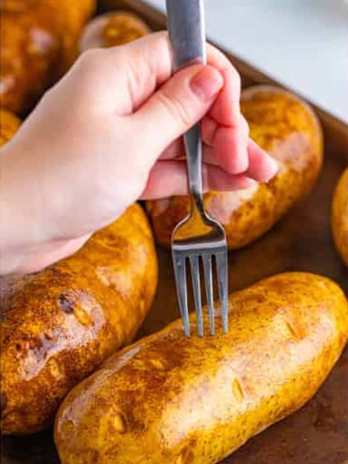 Piercing the potato skin with a fork before slow cooking.