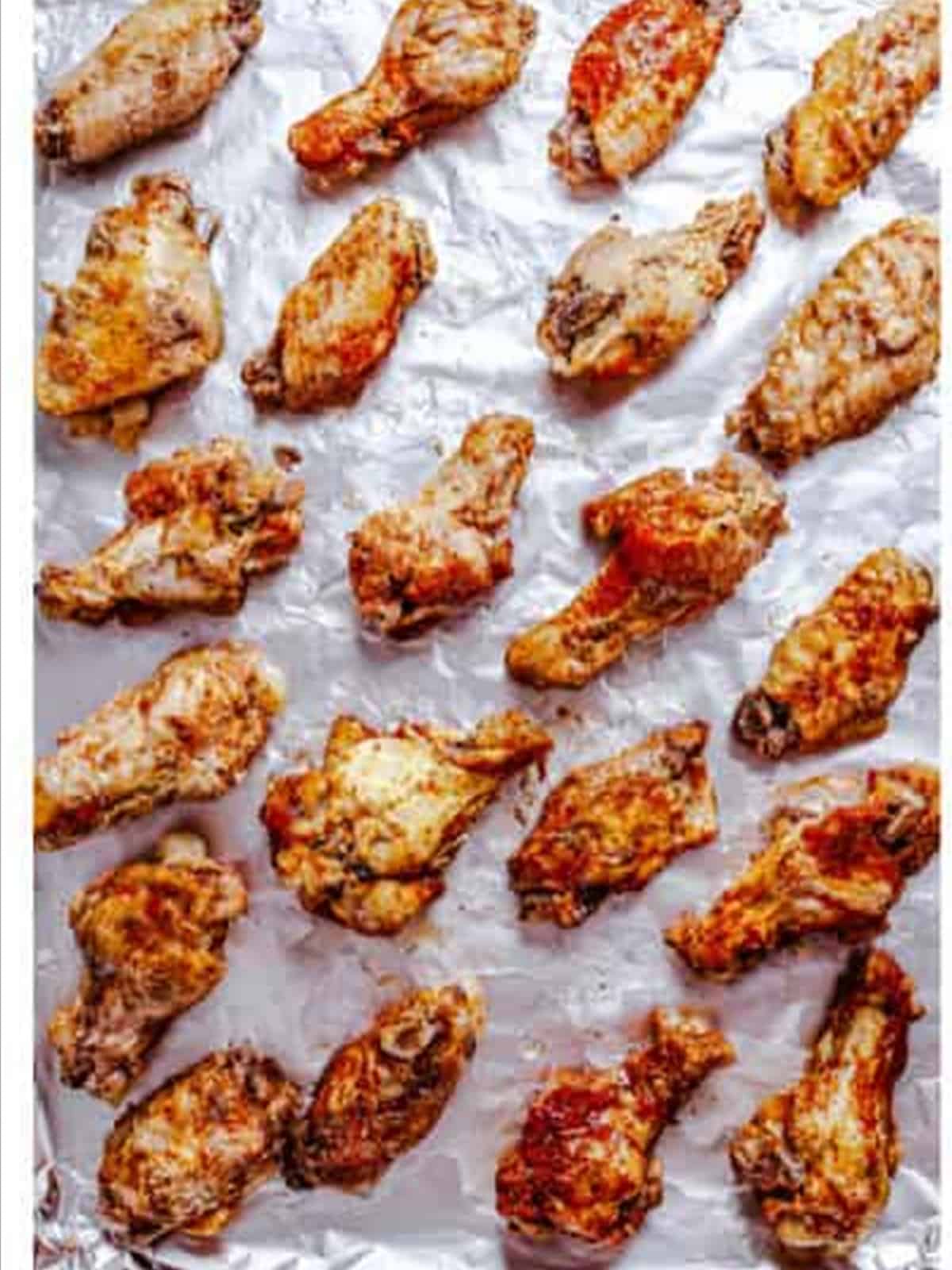 Slow cooked wings on a baking sheet for BBQ chicken wings.