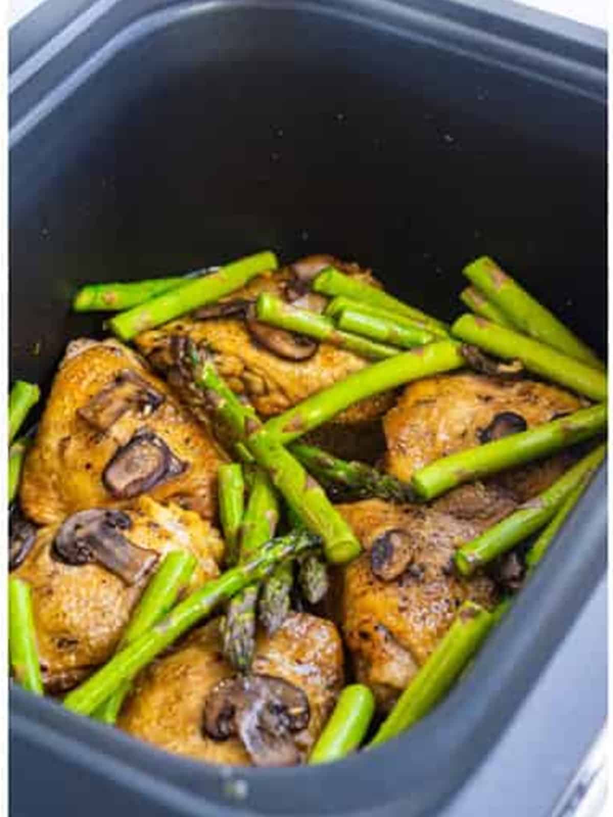 Asparagus pieces added to the slow cooker chicken marsala near the end of cooking.