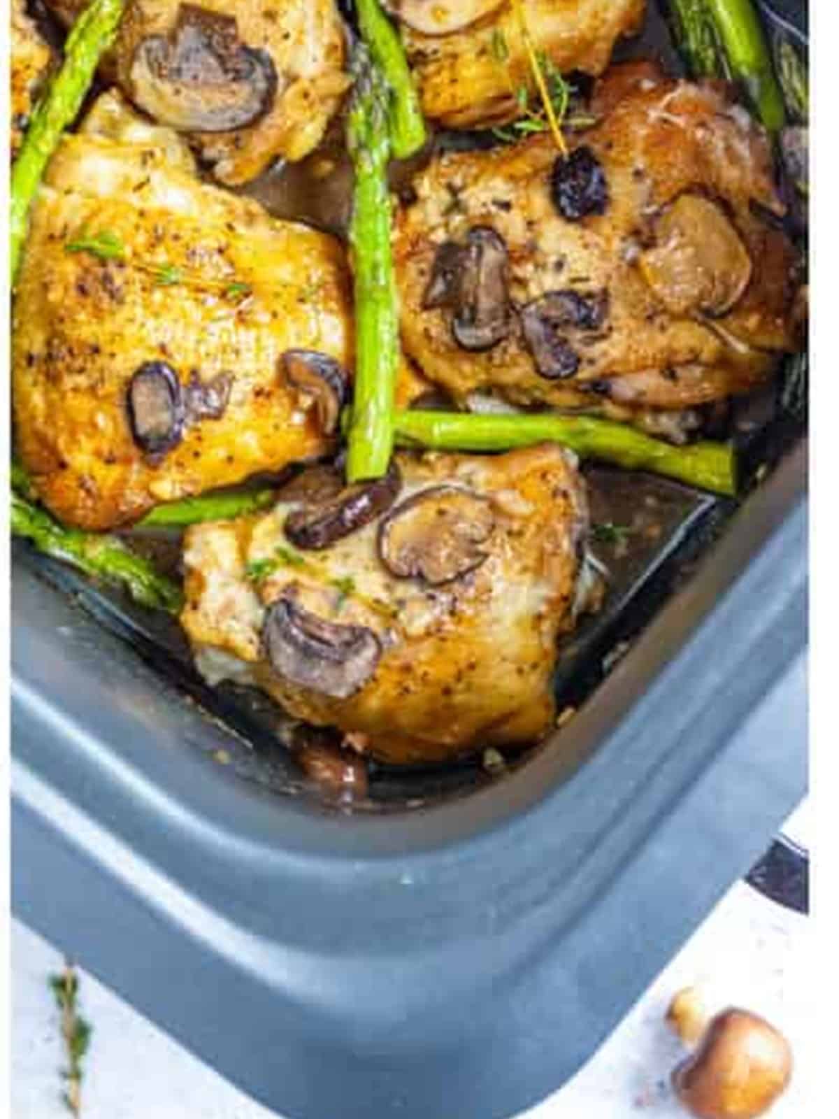 Finished slow cooker chicken marsala with mushrooms and asparagus in the crock.