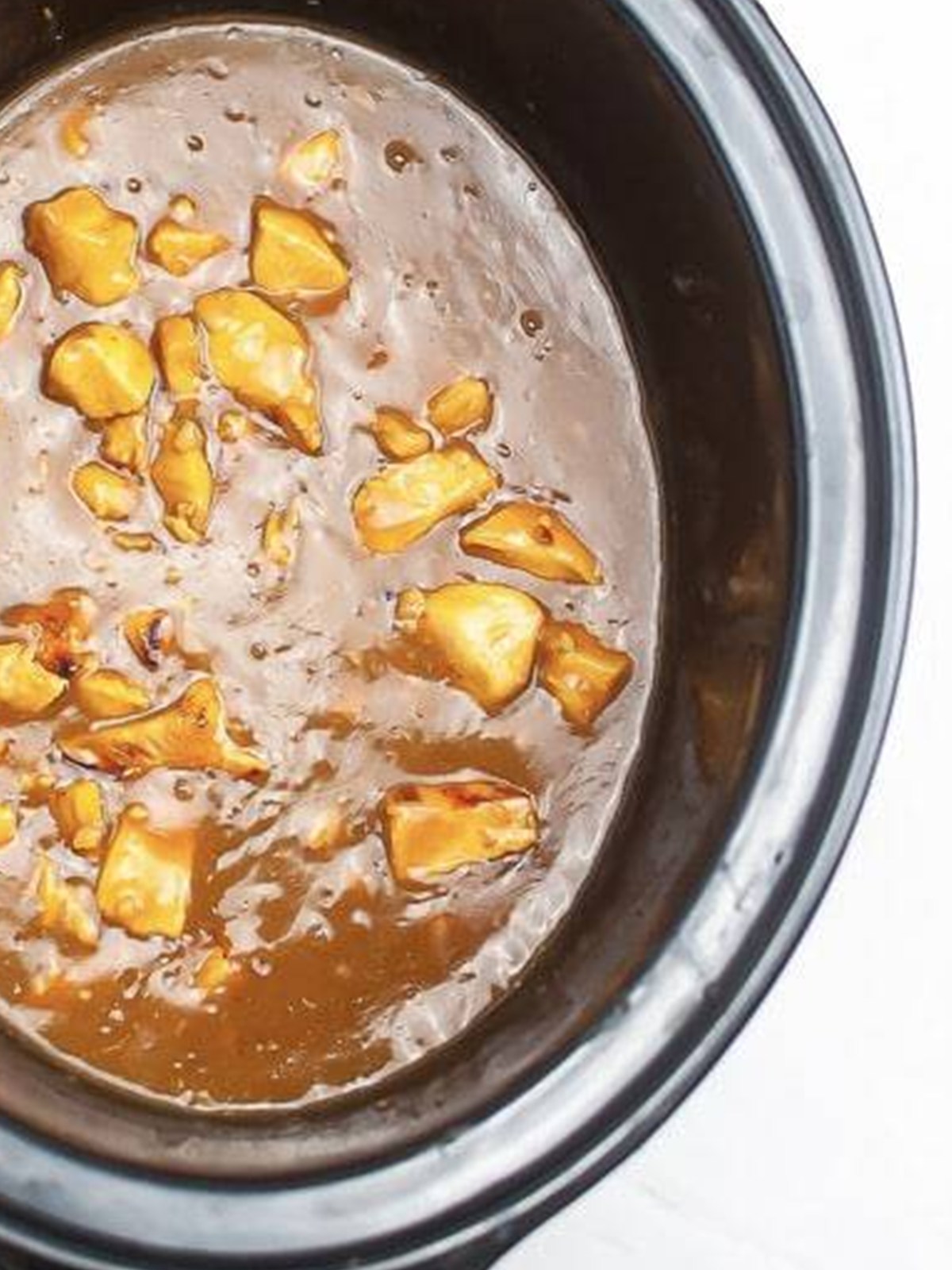 Slow Cooker Chicken Teriyaki cooked in a thick glossy sauce in the crock.