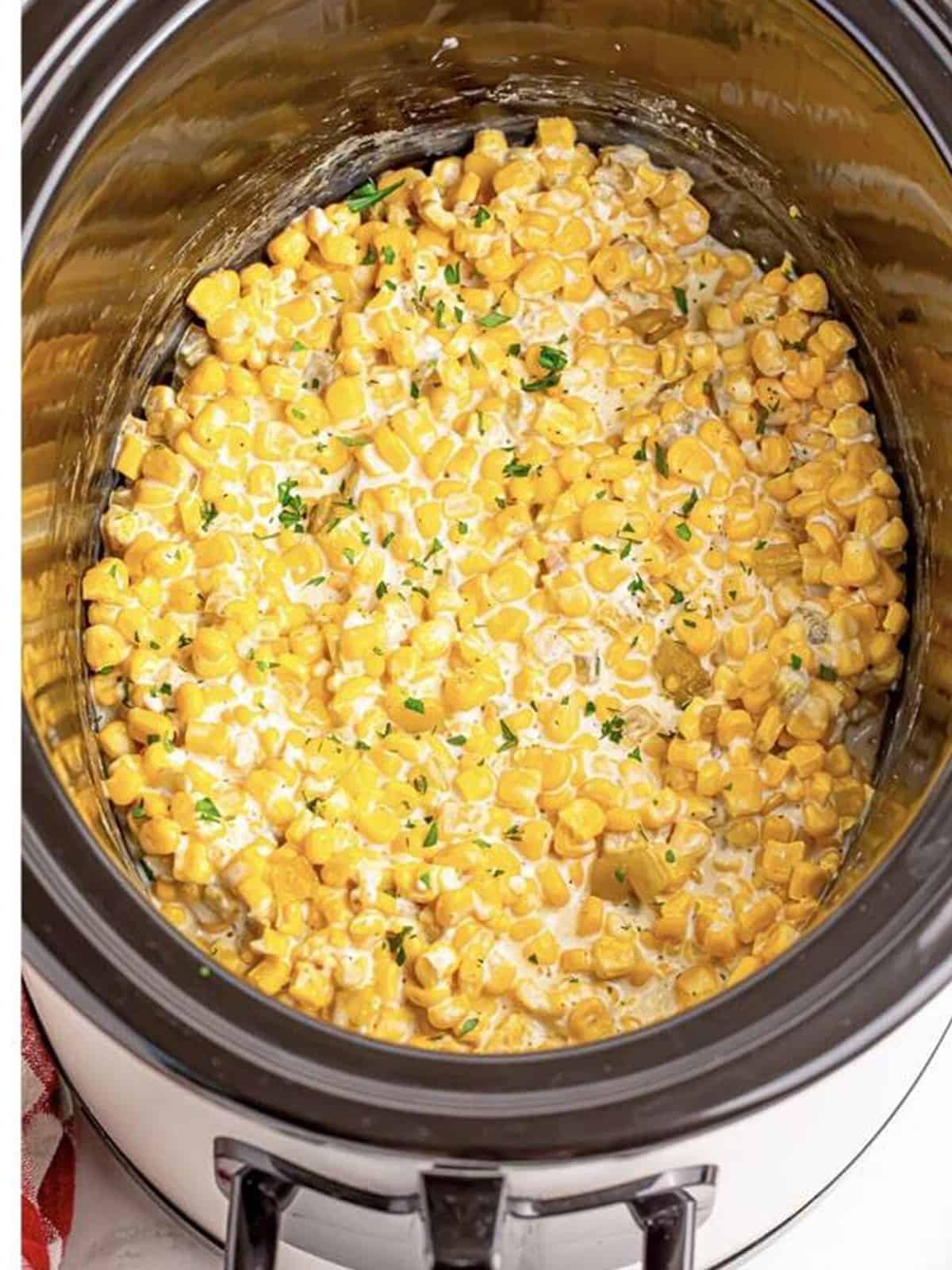 Creamy cooked creamed corn with green chiles stirred together in the slow cooker.
