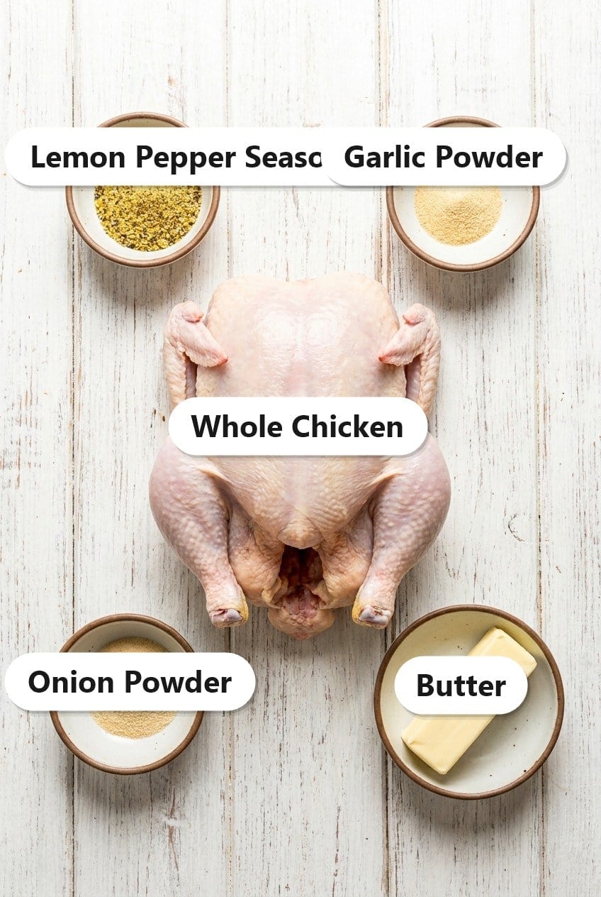 Labeled ingredients for slow cooker lemon pepper chicken including a whole chicken, lemon pepper seasoning, garlic powder, onion powder, and butter.