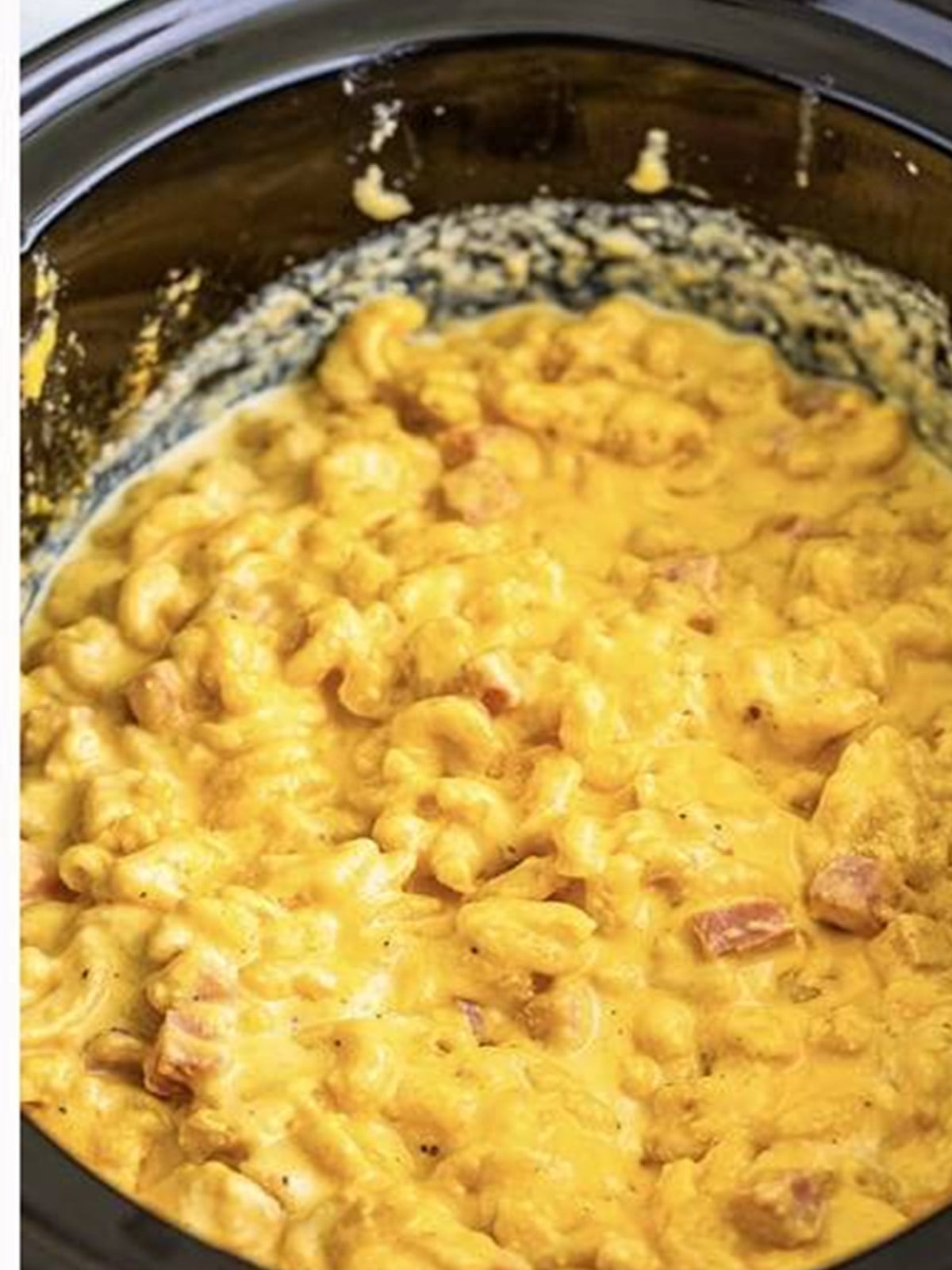 Tender macaroni cooked in the slow cooker with melted cheese and ham.