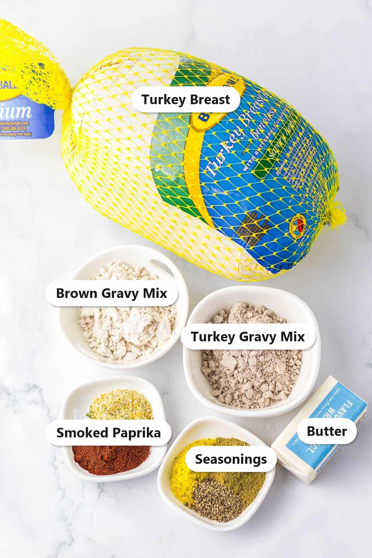 Labeled ingredients for slow cooker turkey breast including turkey breast, brown gravy mix, turkey gravy mix, smoked paprika, seasonings, and butter.