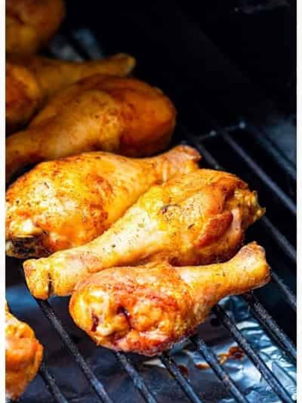 Smoked chicken legs cooked on the smoker grates.