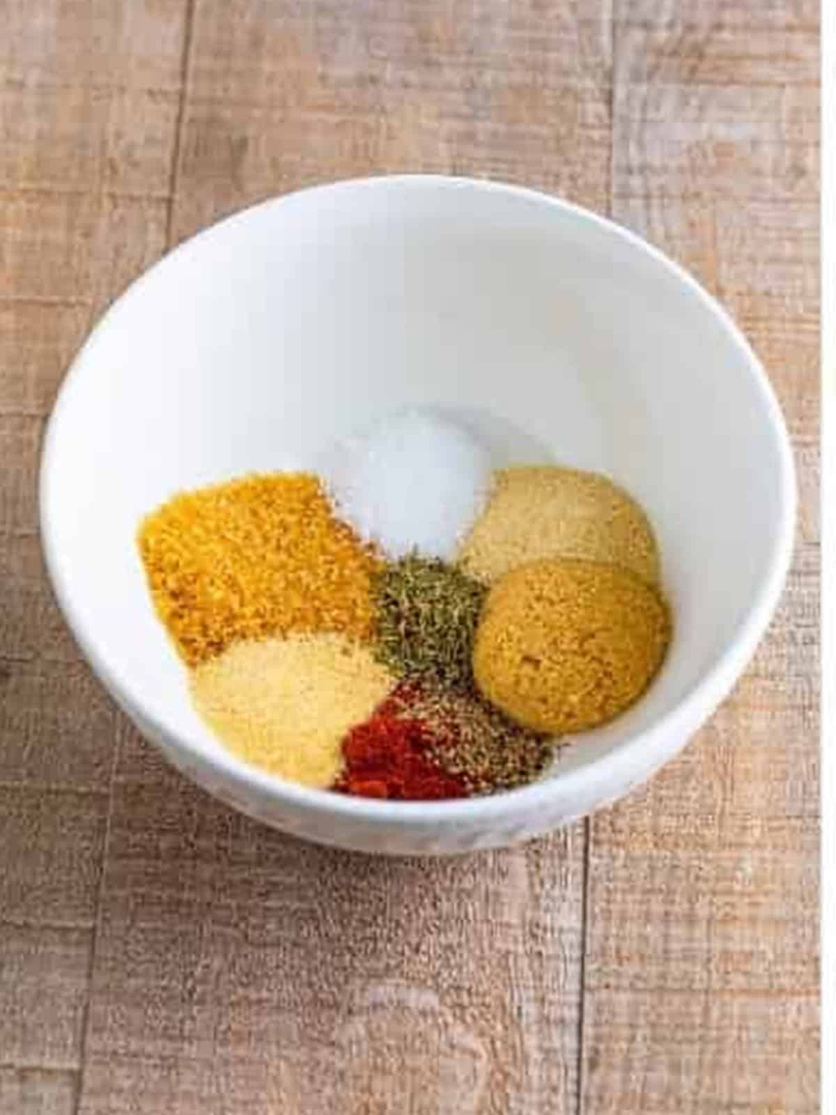 Rub spices measured into a bowl for Smoked Chicken Thighs.