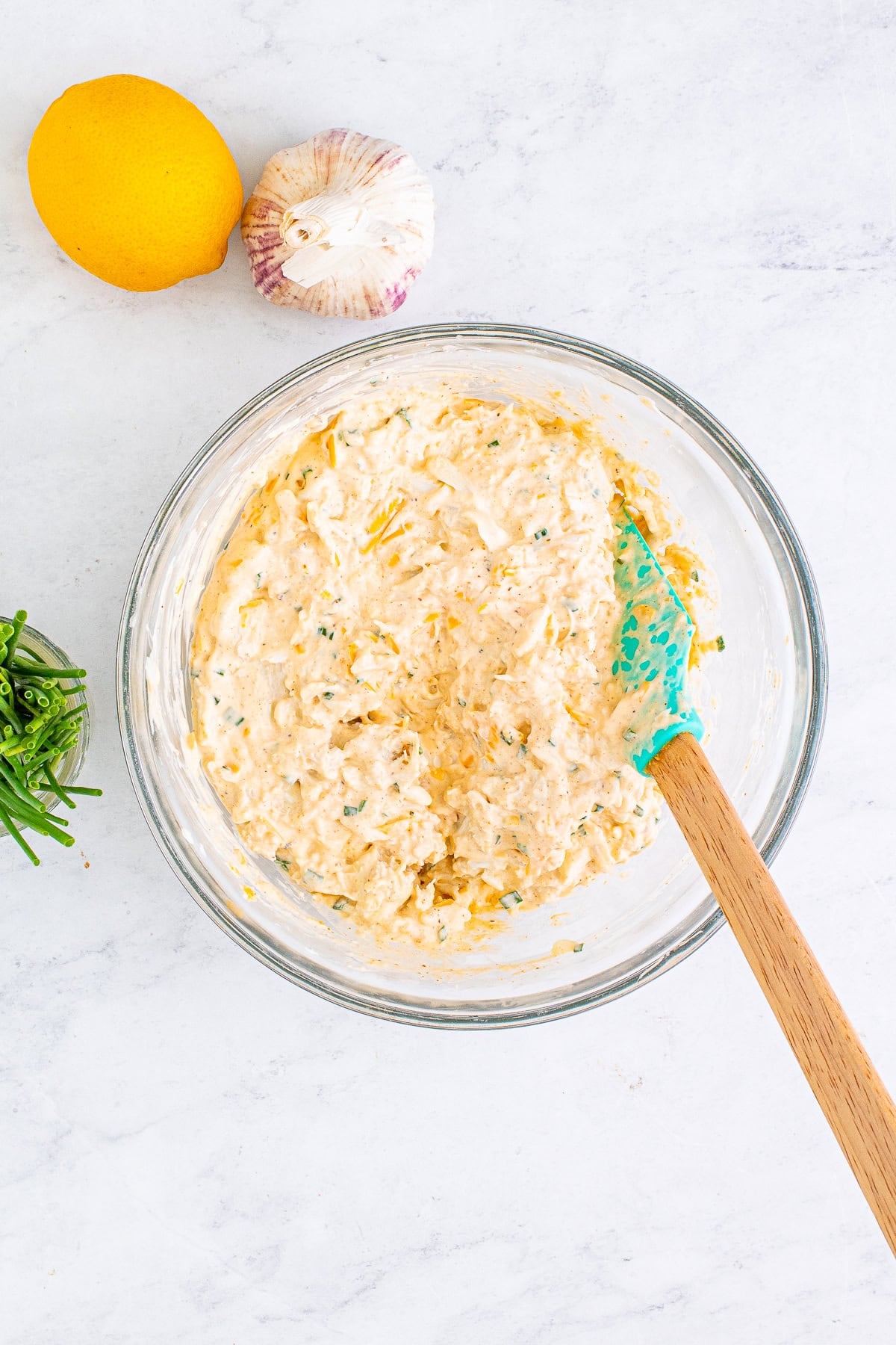 Creamy crab dip base mixed in a glass bowl.