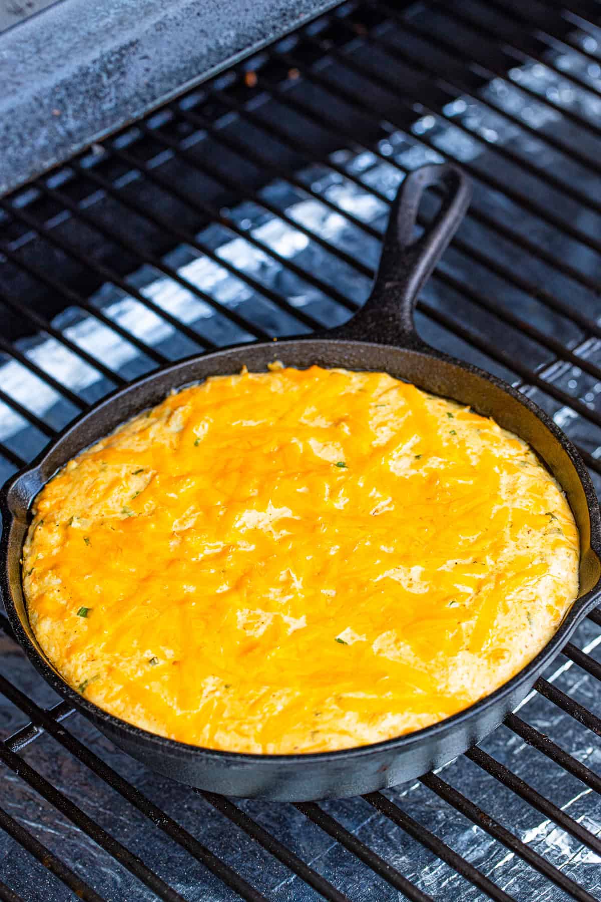 Crab dip on the smoker with melting cheese.