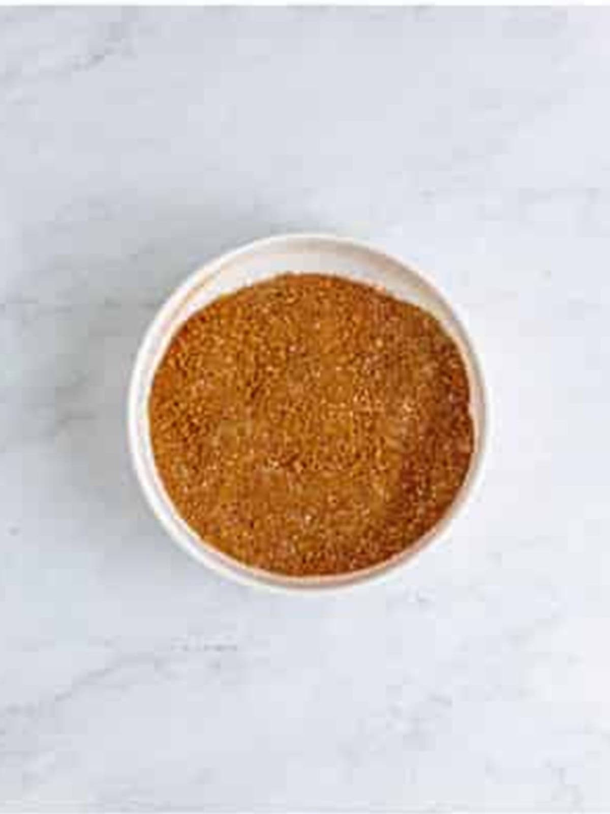 A bowl of dry rub spices mixed together for smoked ribs.