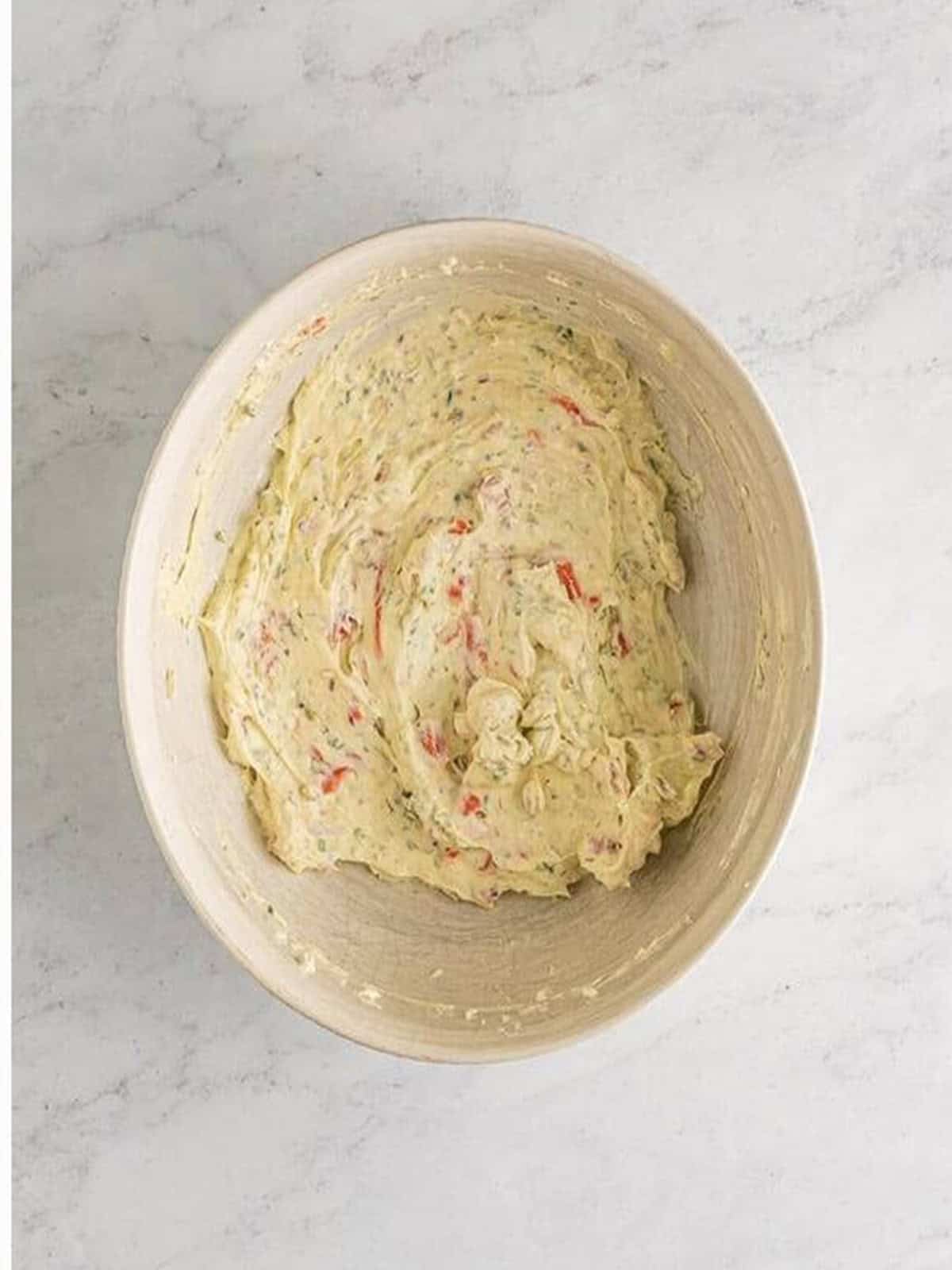 Finished smoked salmon dip with salmon folded throughout the creamy base.