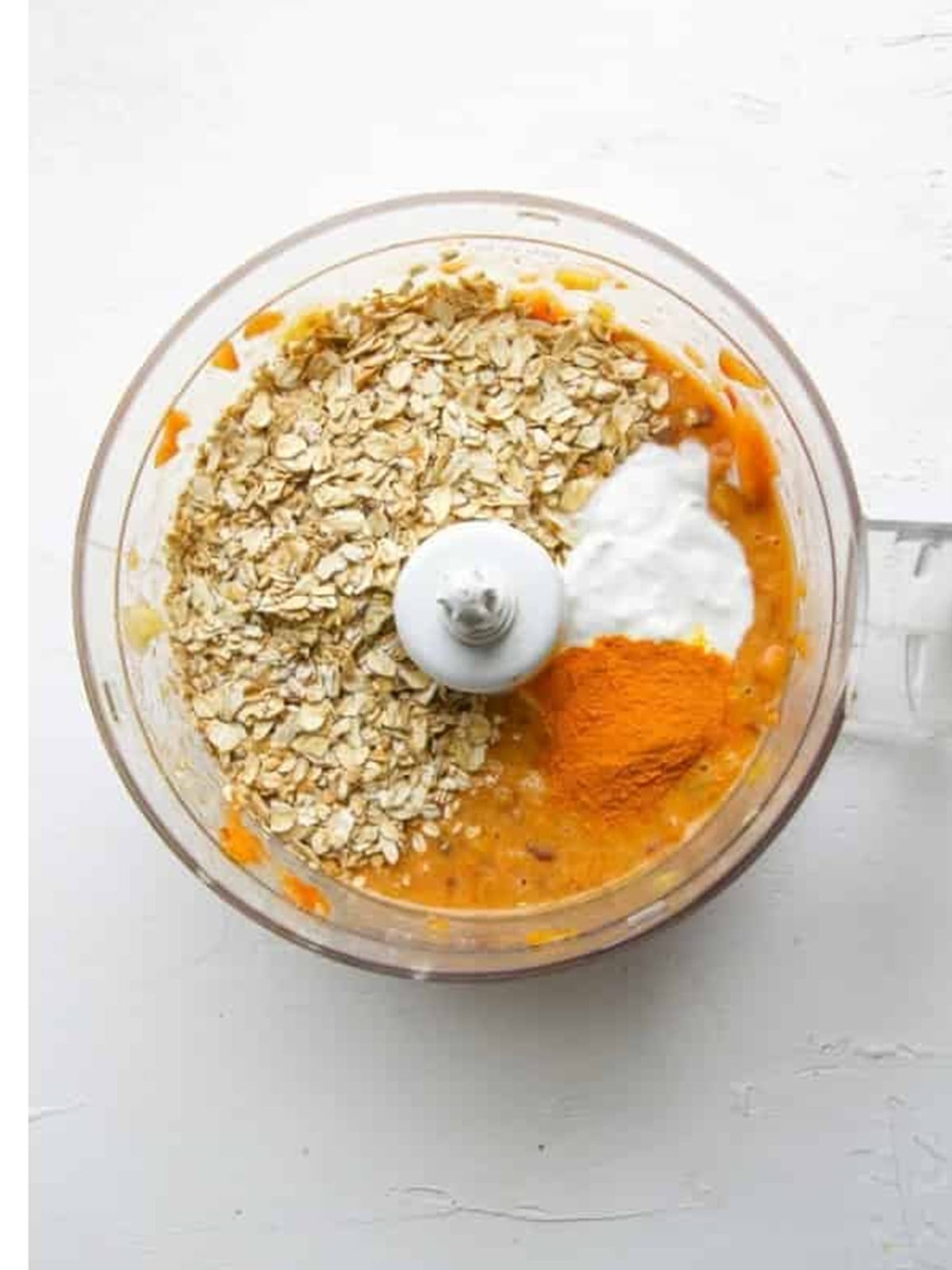 Rolled oats, coconut cream, and turmeric added to the blended fruit for a smoothie bowl.