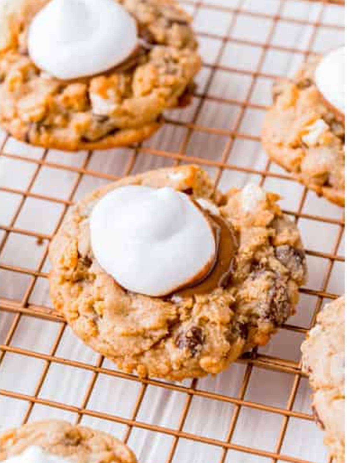 Marshmallow fluff piped onto the chocolate center of each cookie.