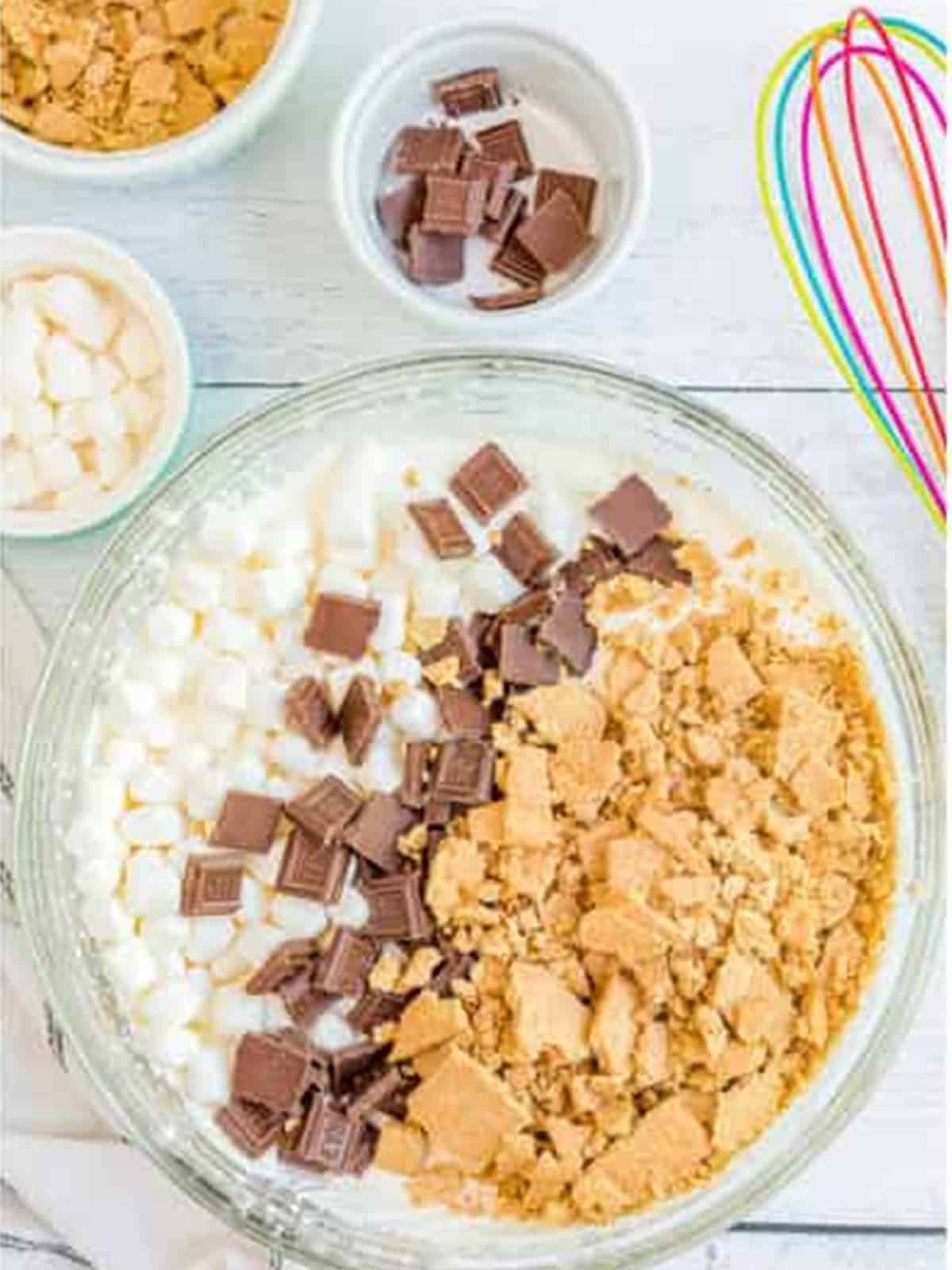 Crushed graham crackers, mini marshmallows, and chopped chocolate added to the ice cream base.
