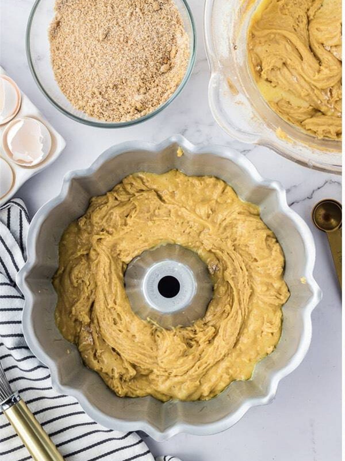 Half of the batter spread in a Bundt pan.