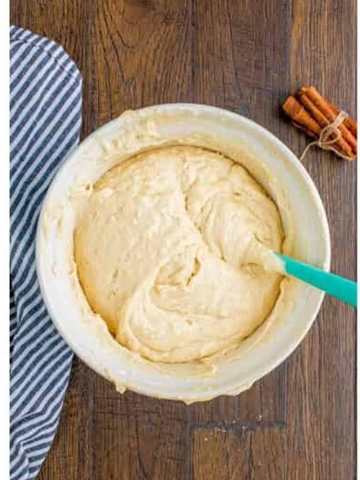 Sour cream coffee cake batter whisked smooth in a bowl.