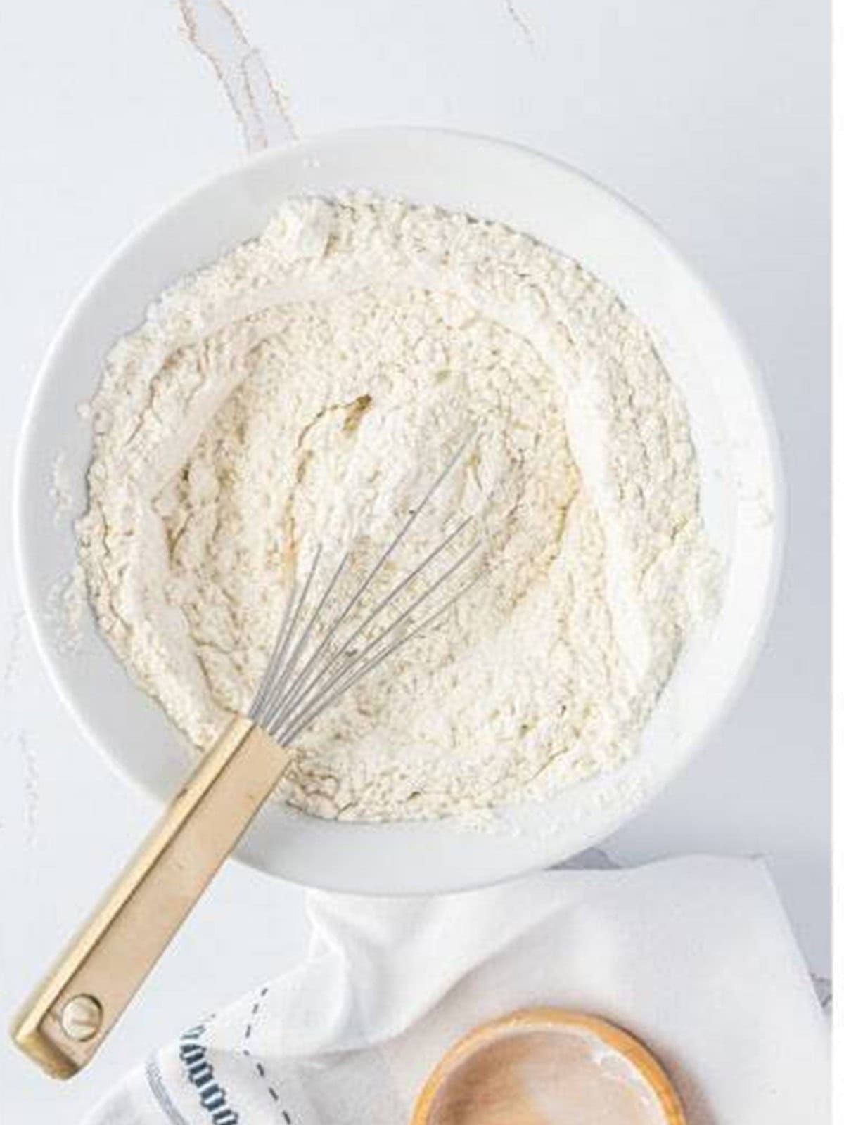 Flour, baking soda, baking powder, and salt whisked together for sour cream coffee cake.