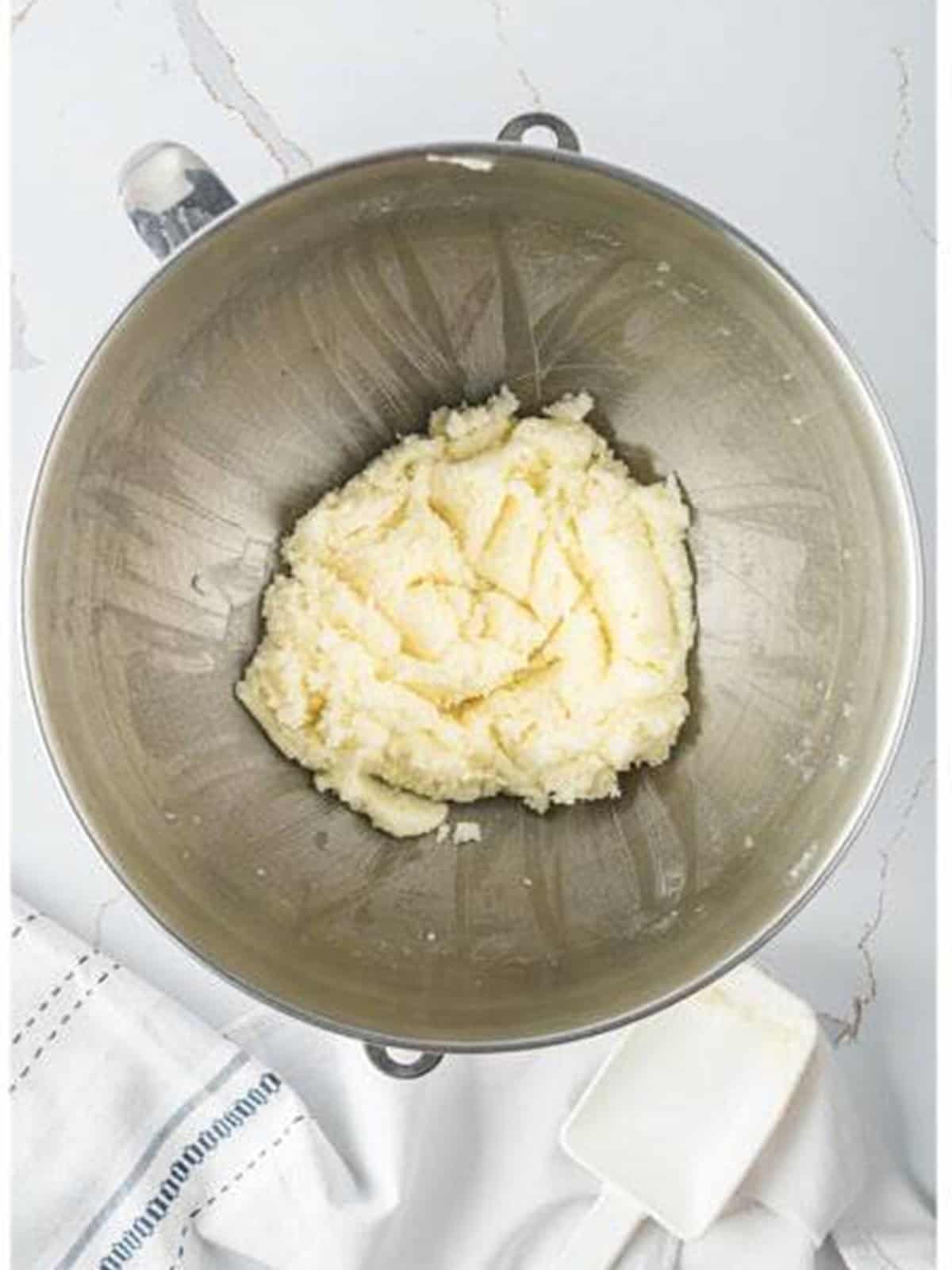 Softened butter and sugar creamed together in a stand mixer bowl.
