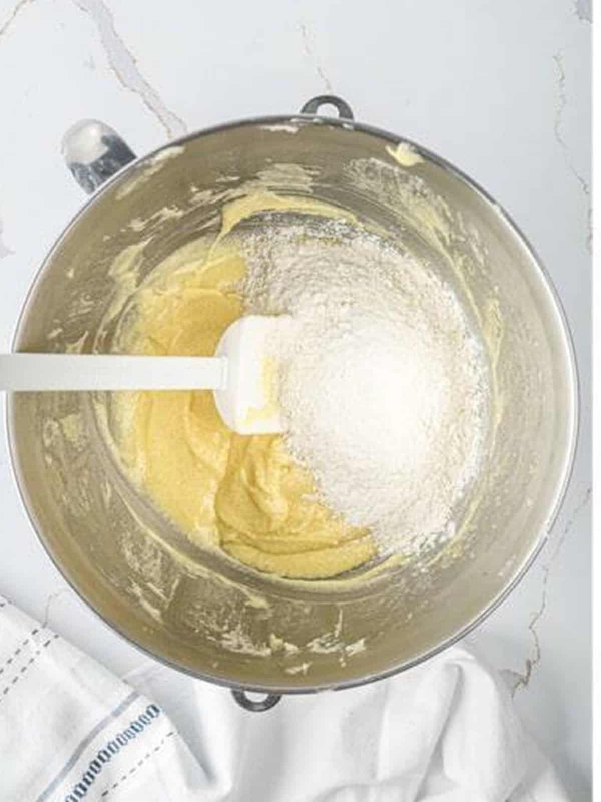 Dry ingredients added to the batter alternating with sour cream.