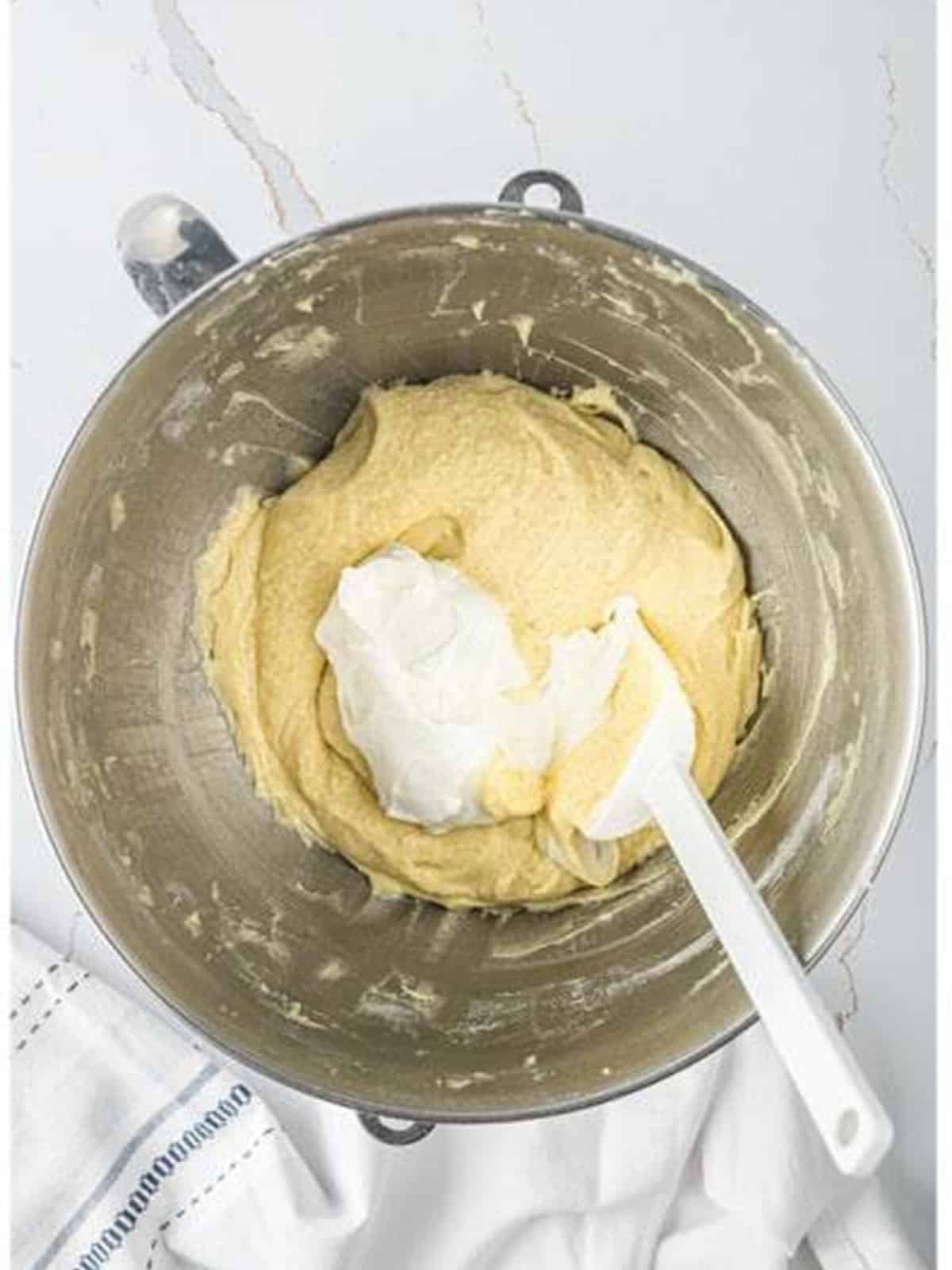 Sour cream added to the coffee cake batter in the mixer bowl.