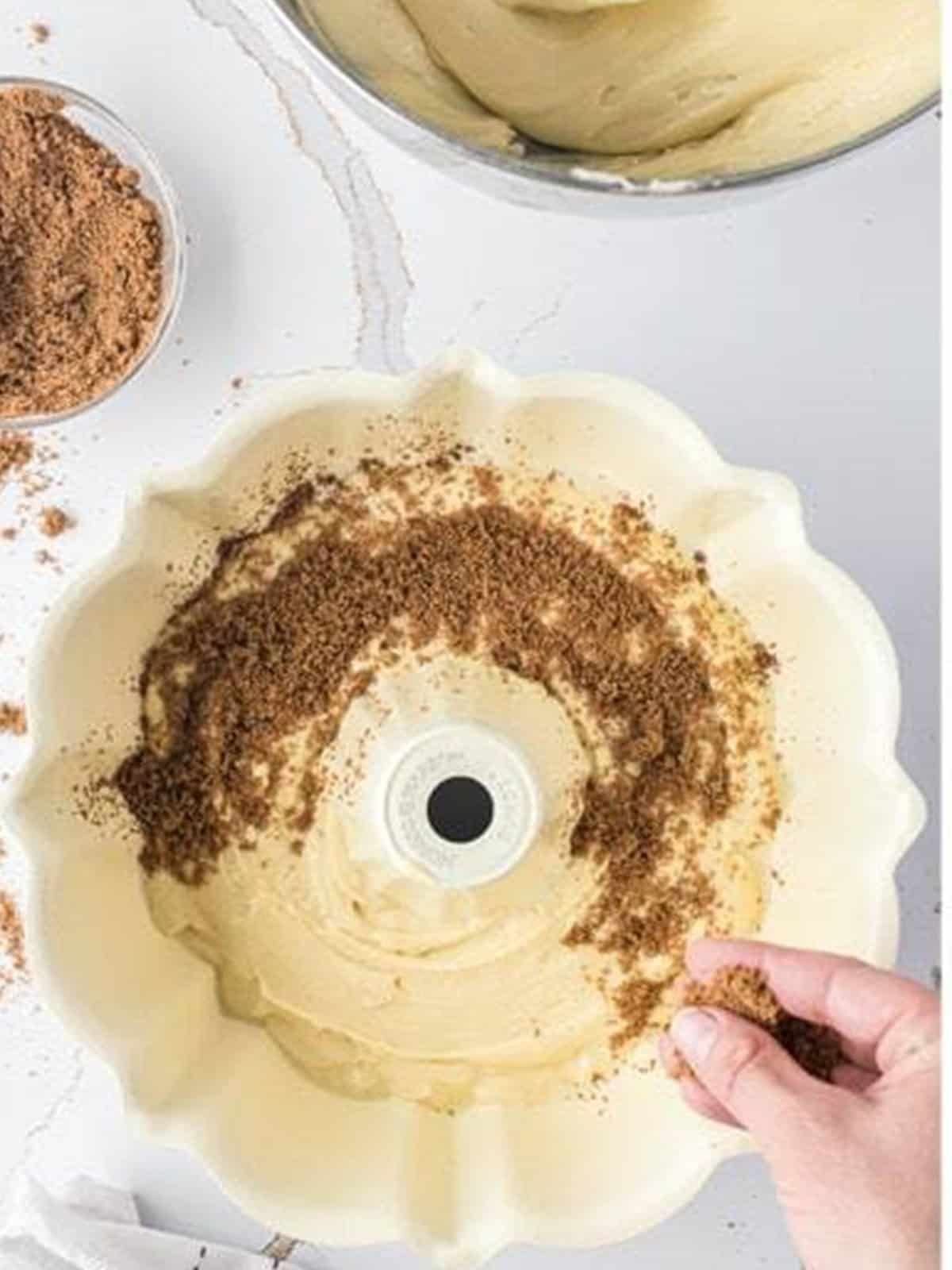 Cinnamon brown sugar filling sprinkled over the first batter layer in the bundt pan.