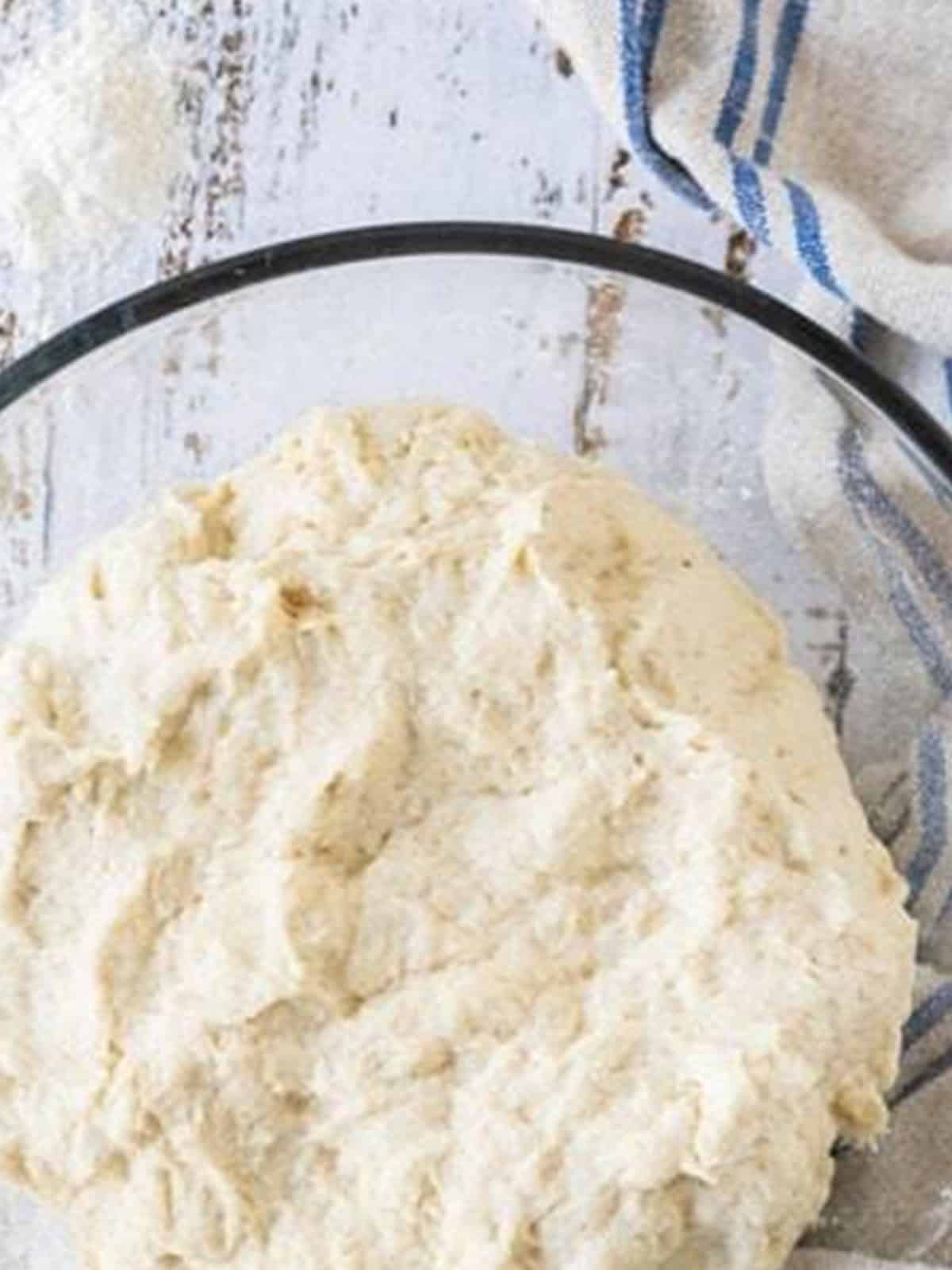 A shaggy sourdough dough mixed together in a bowl for sourdough bread recipe.