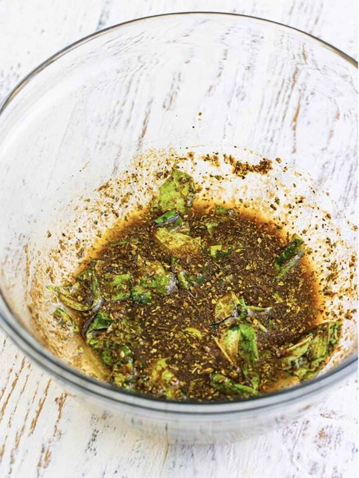 Marinade for sous vide chicken breast whisked together in a glass bowl.