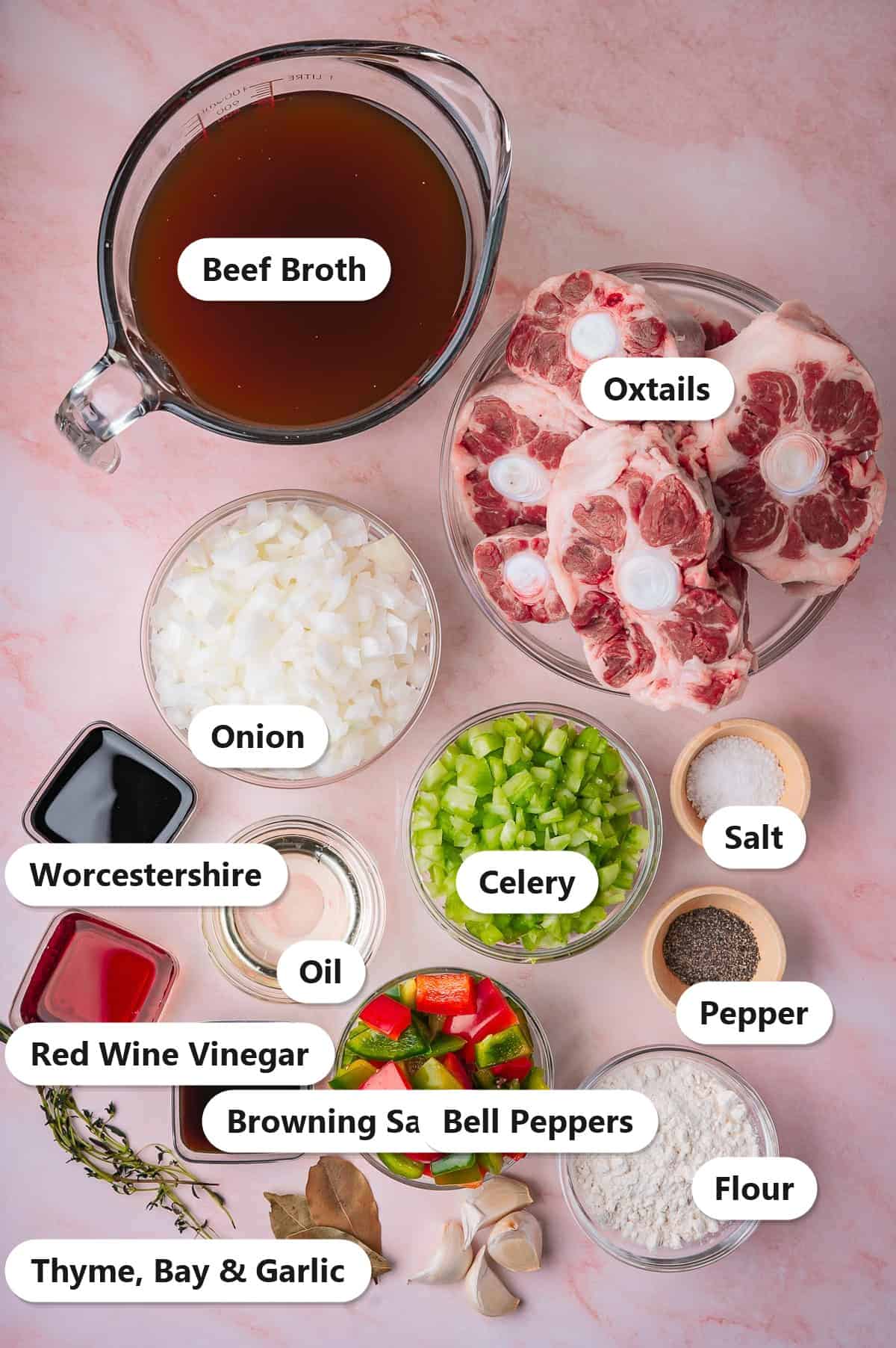 Labeled ingredients for southern braised oxtails including oxtails, beef broth, onion, celery, bell peppers, flour, Worcestershire, and seasonings.