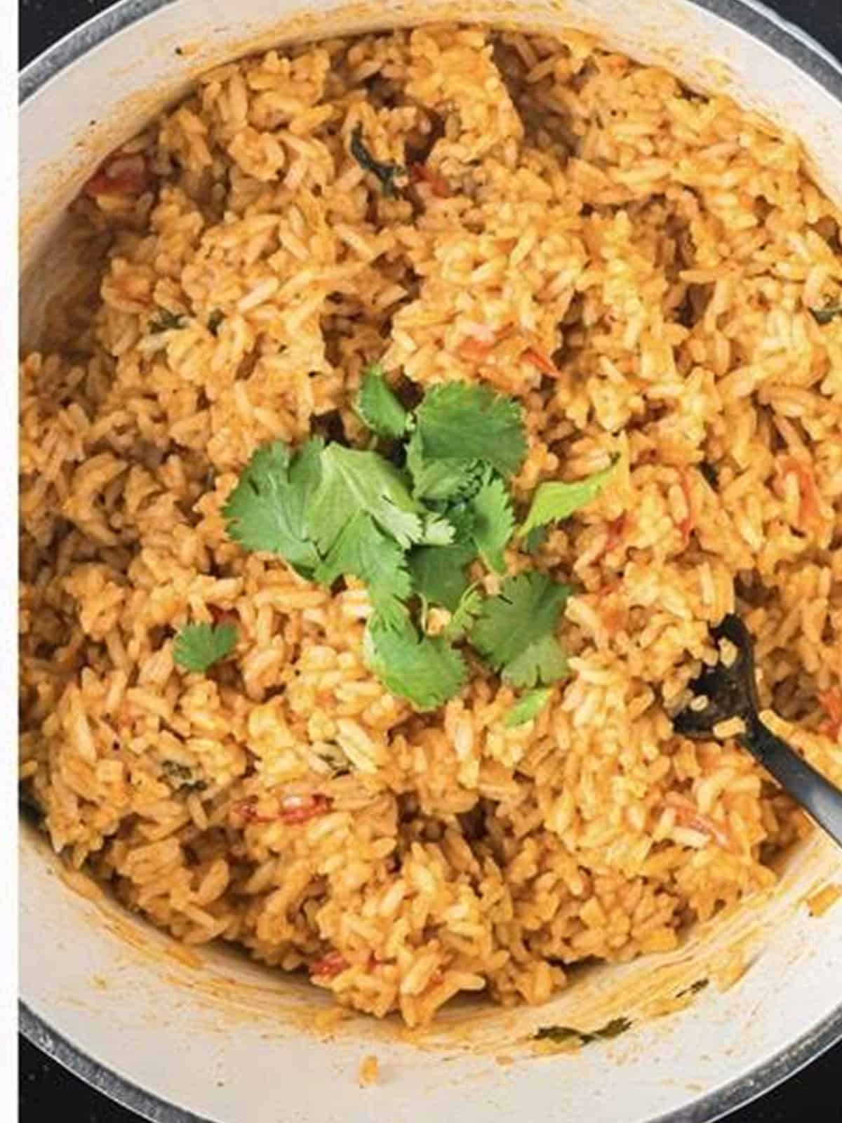 Fluffed finished Spanish Rice garnished with fresh cilantro.
