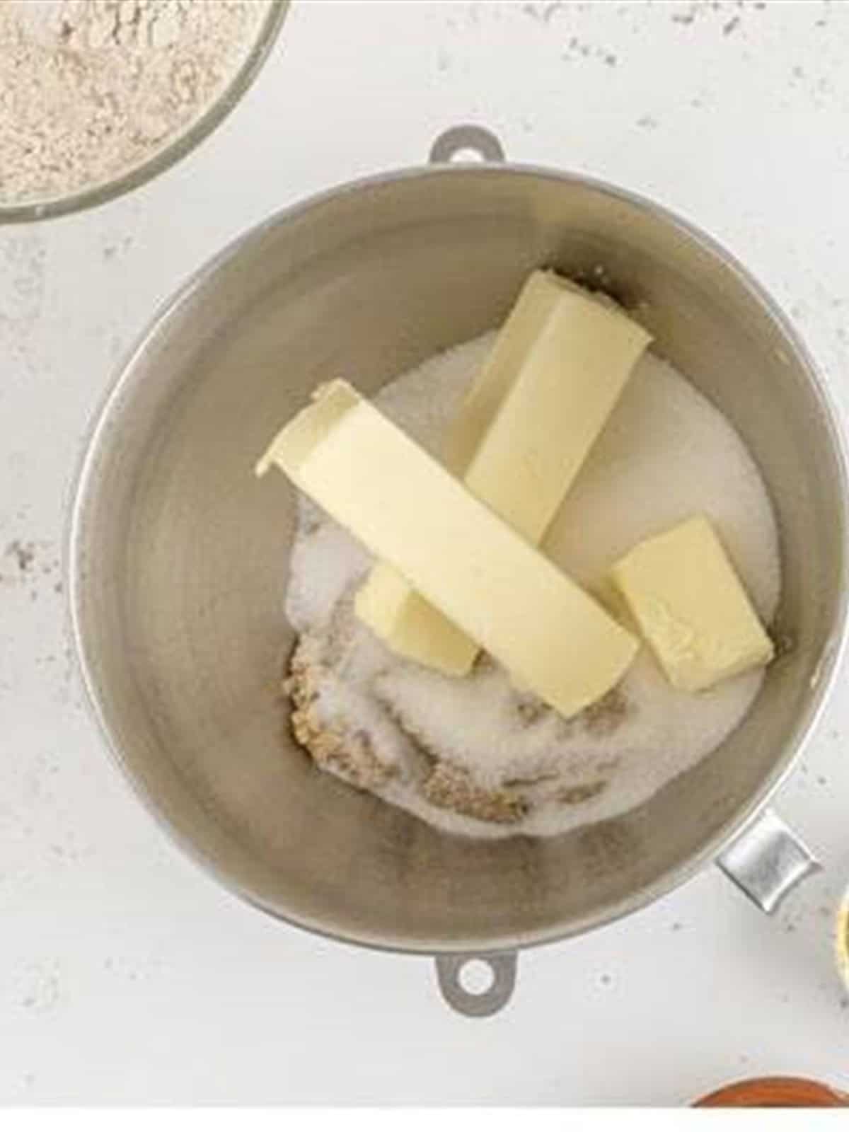 Butter and sugars in a stand mixer bowl.