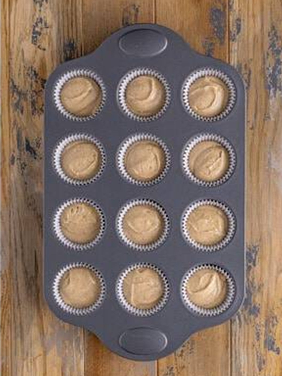 Spice cupcake batter portioned into a lined cupcake tin.