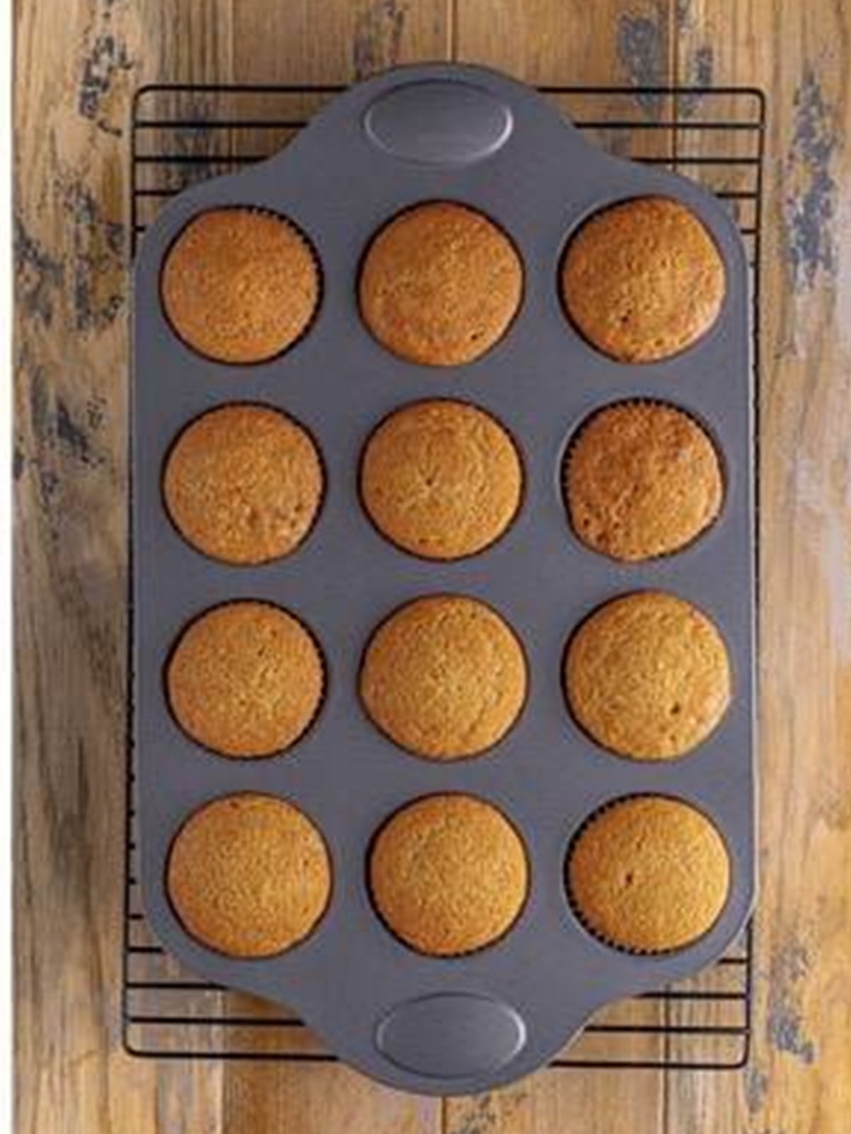 Baked spice cupcakes cooling in the cupcake tin.