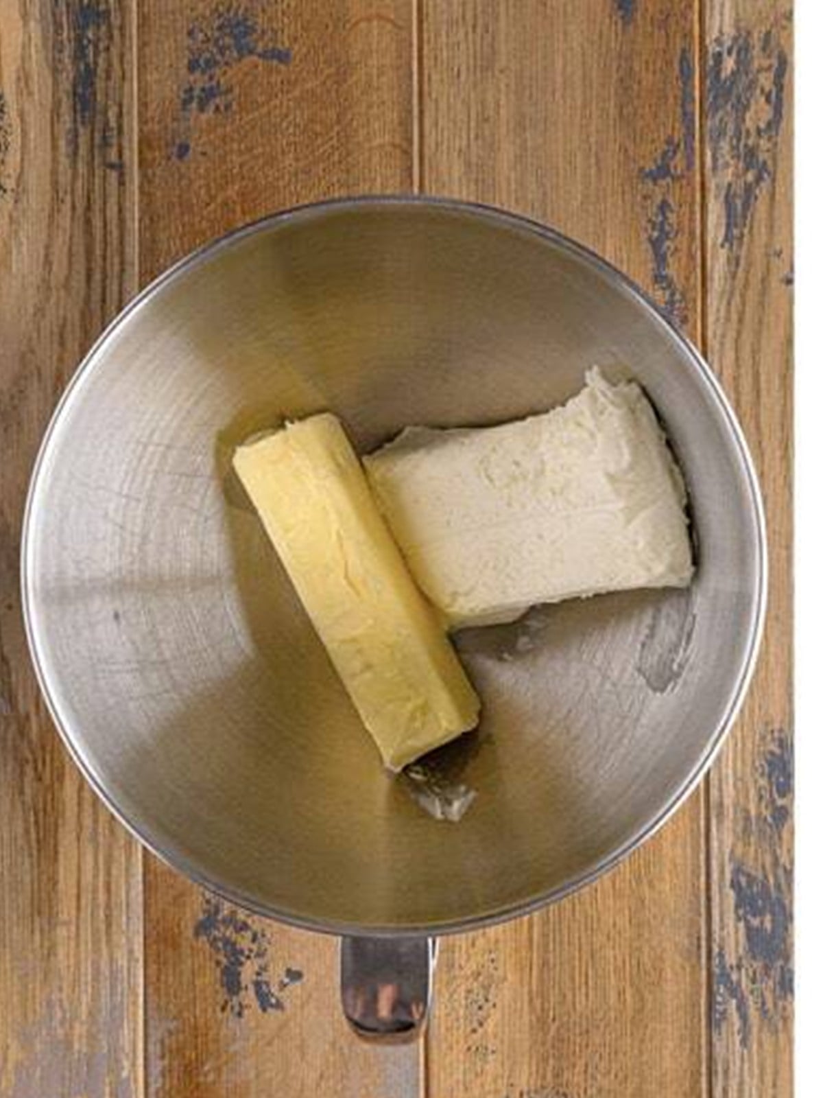 Cream cheese and butter being creamed for frosting.