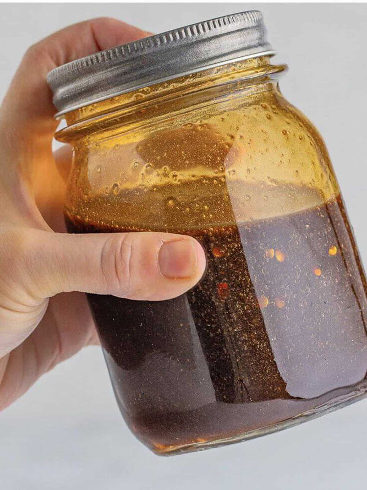 Spicy pad thai sauce with tamarind, fish sauce, and palm sugar shaken in a mason jar.
