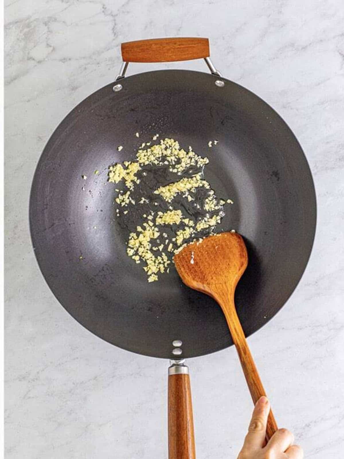 Minced garlic cooking in oil in the wok until fragrant.