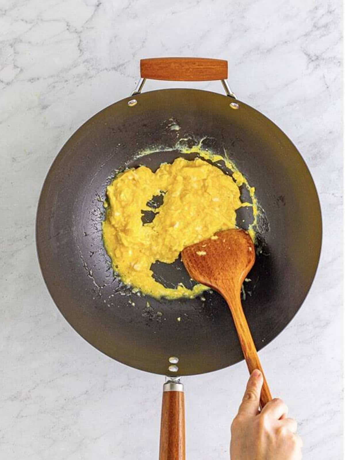 Beaten eggs scrambled in the wok until just set.